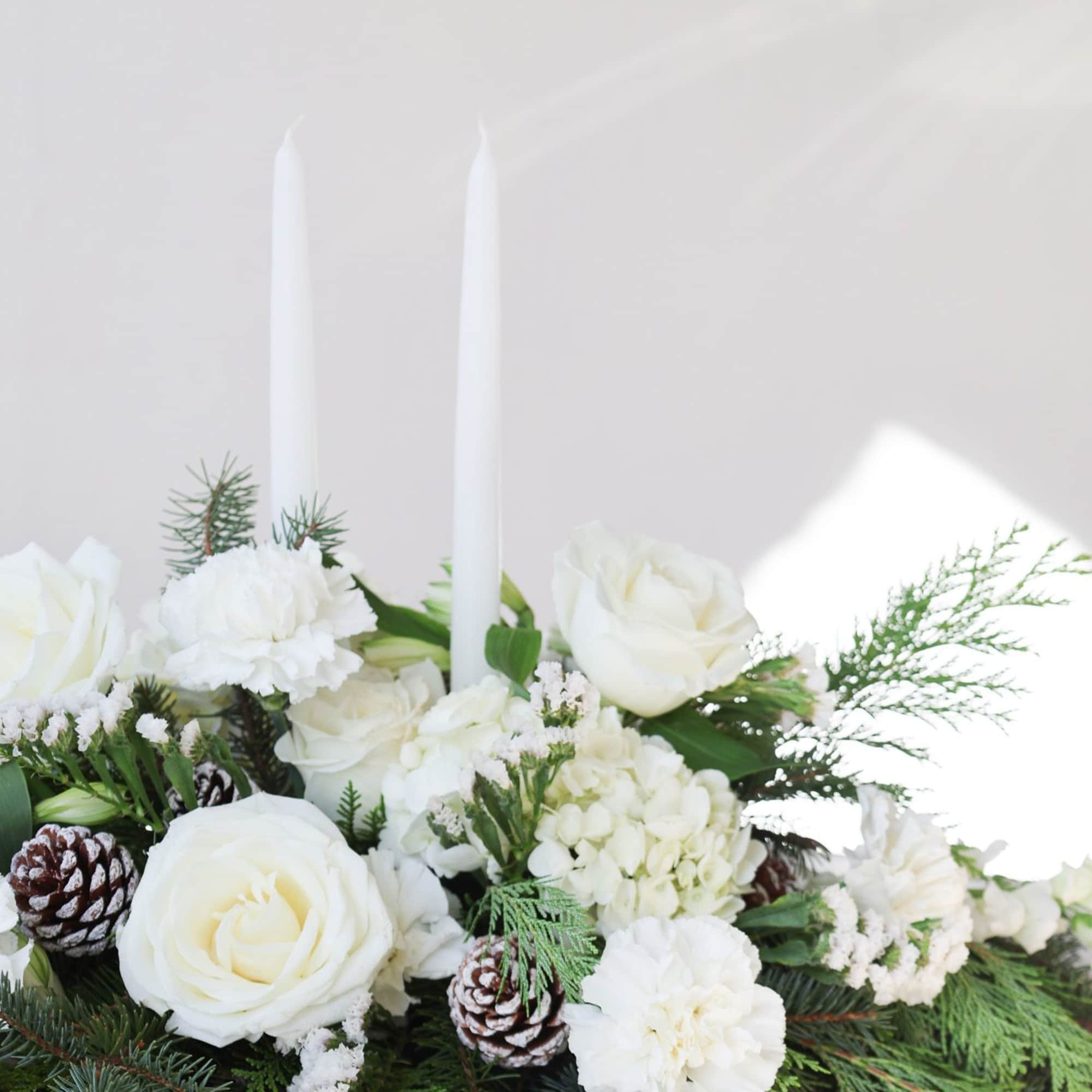 Holiday Centerpiece with wintergreens and crisp white florals

includes two 15" taper candles