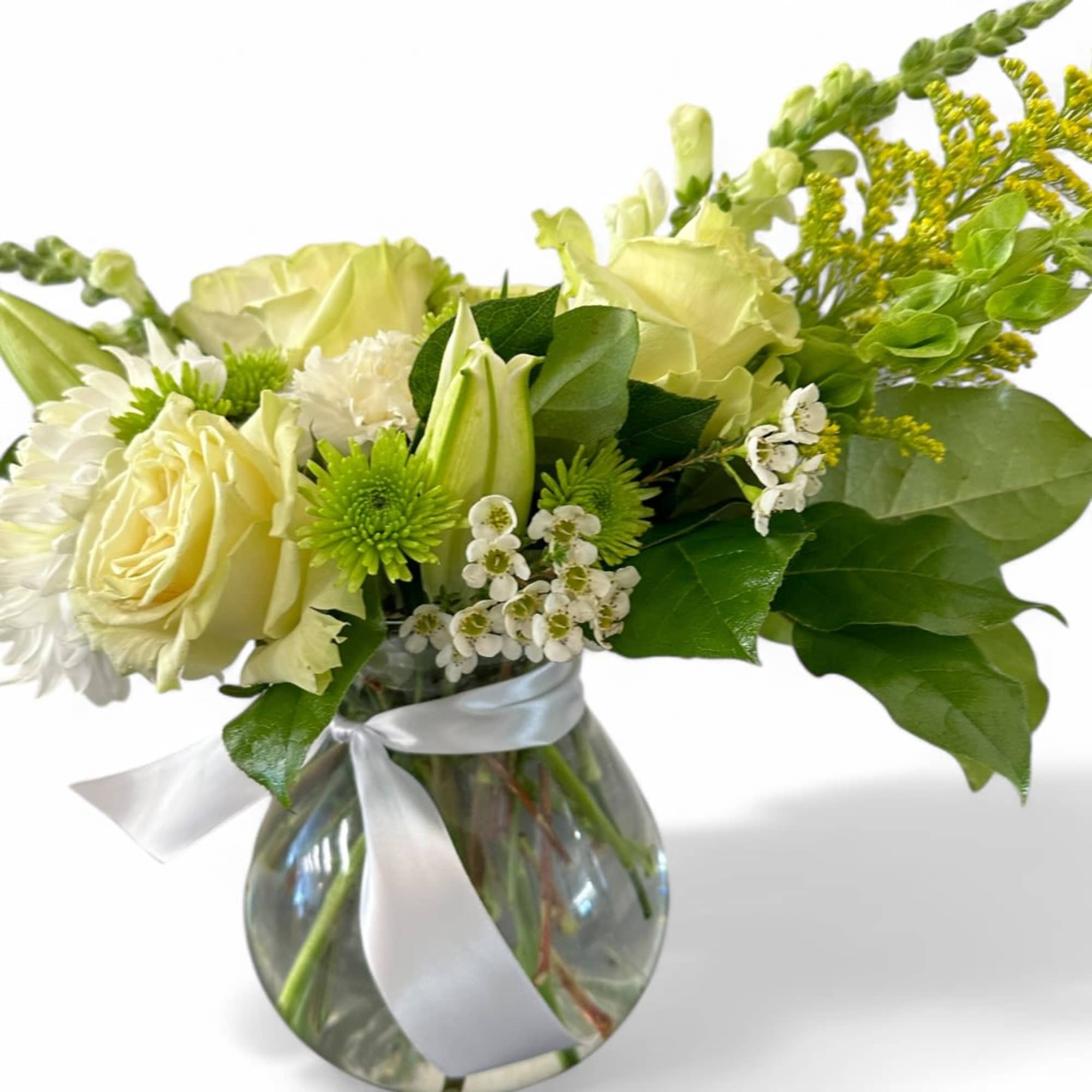 This stunning vase arrangement features an enchanting blend of white and green