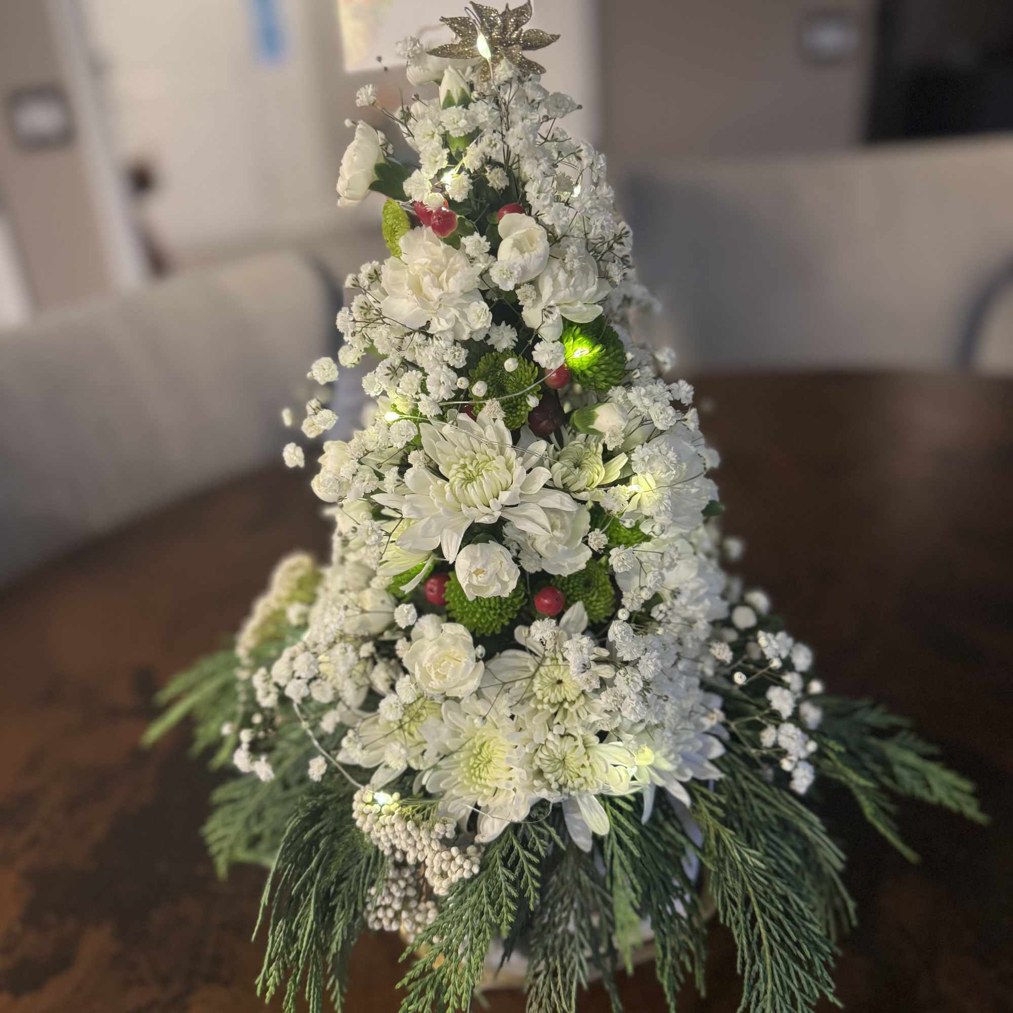 This magical tree has fresh pine, white mums, Roses, hypericum berries garland