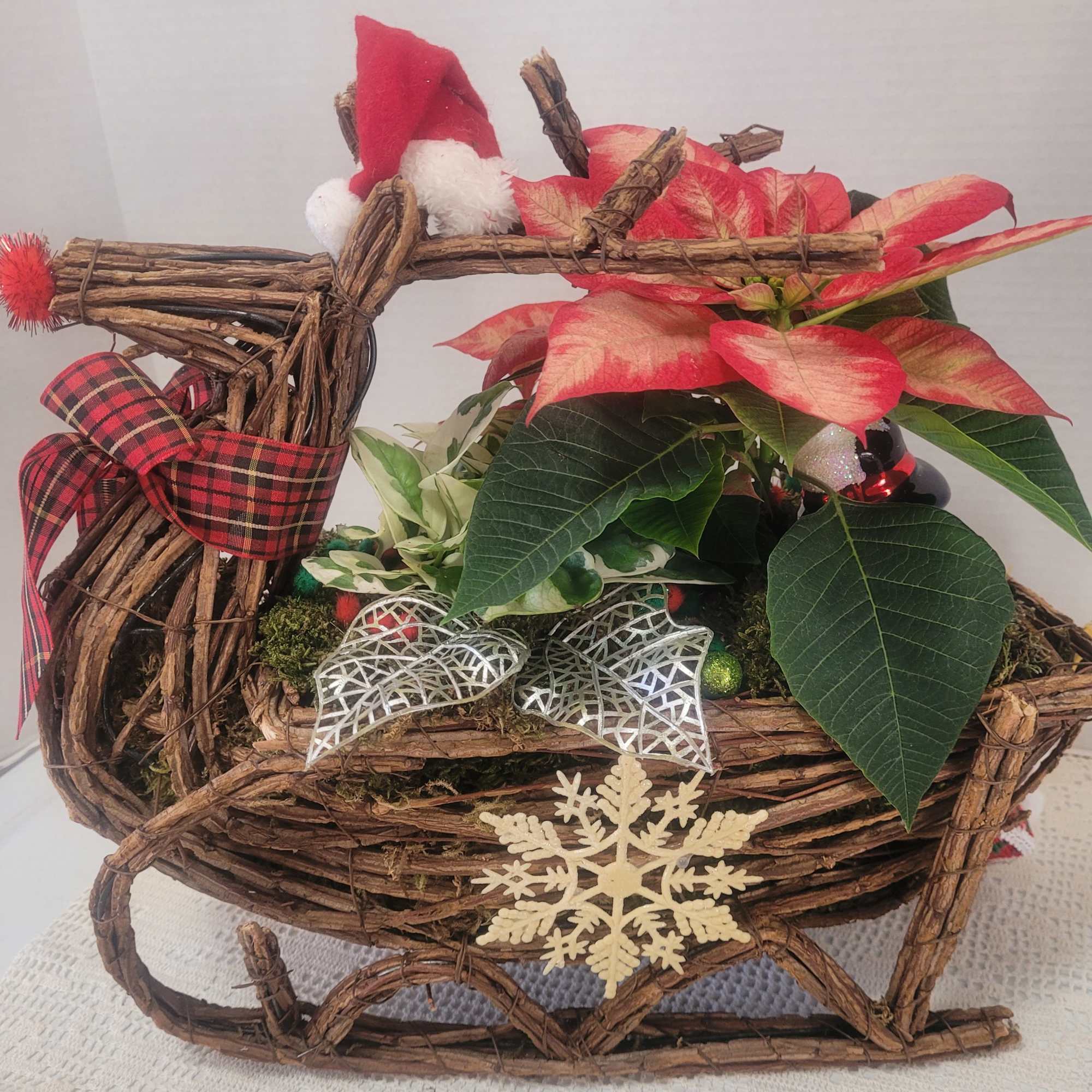 A festive wicker reindeer featuring holiday colors and lots of faux embellishments.