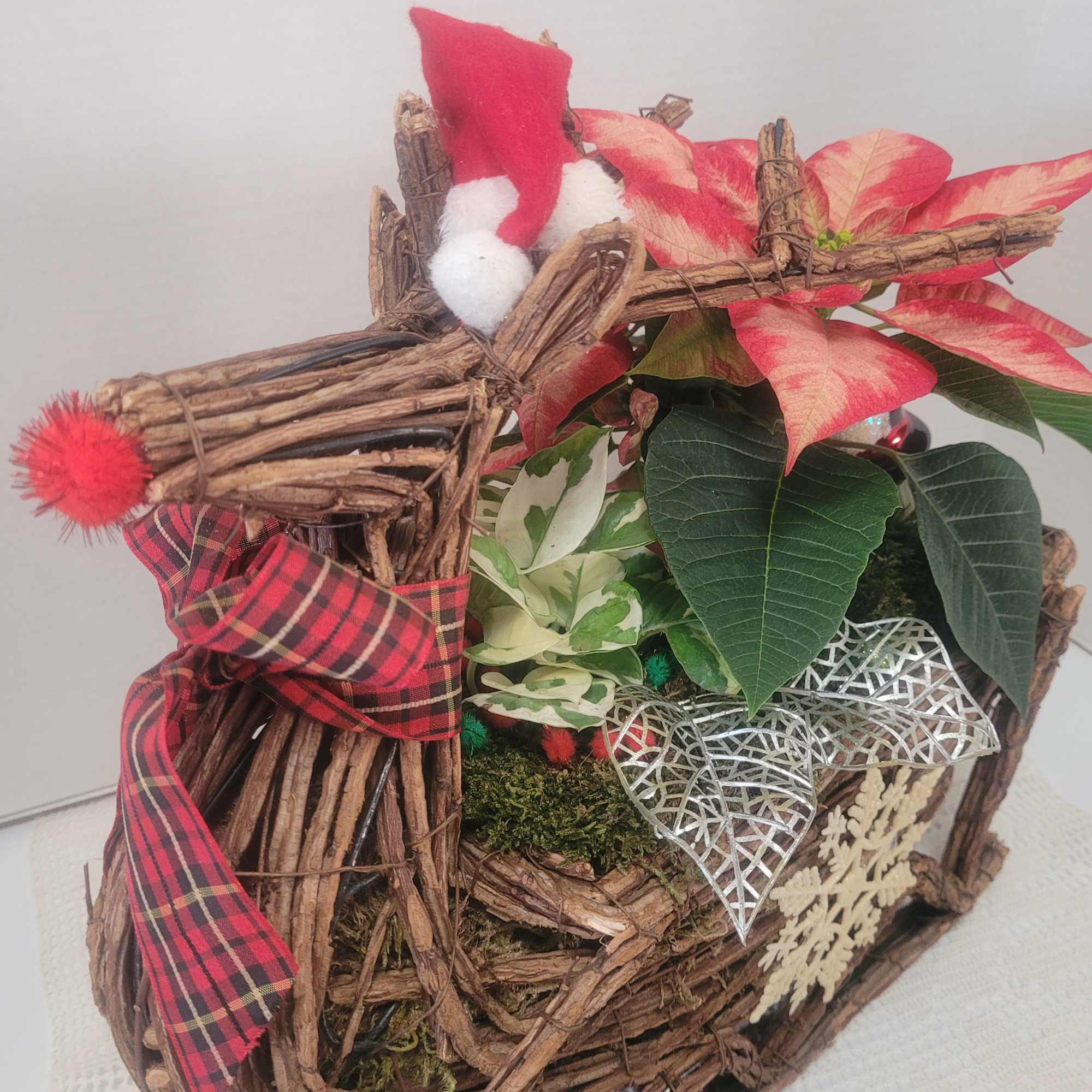 A festive wicker reindeer featuring holiday colors and lots of faux embellishments.
