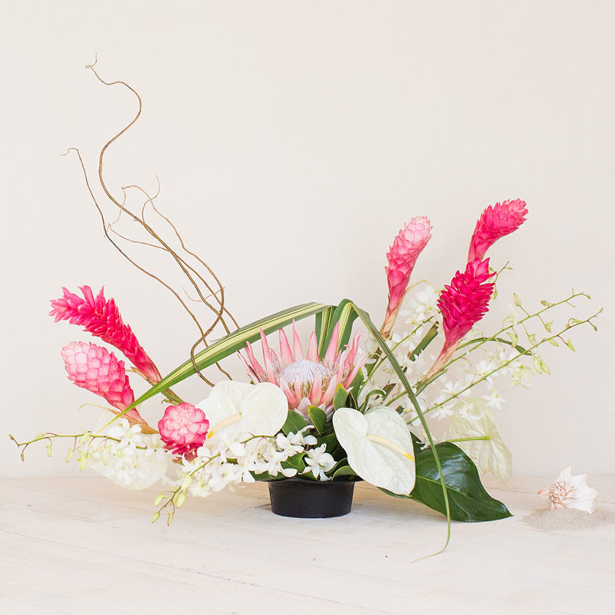 Trendy and Fun, this arrangement features exotic tropical flowers that exude elegance