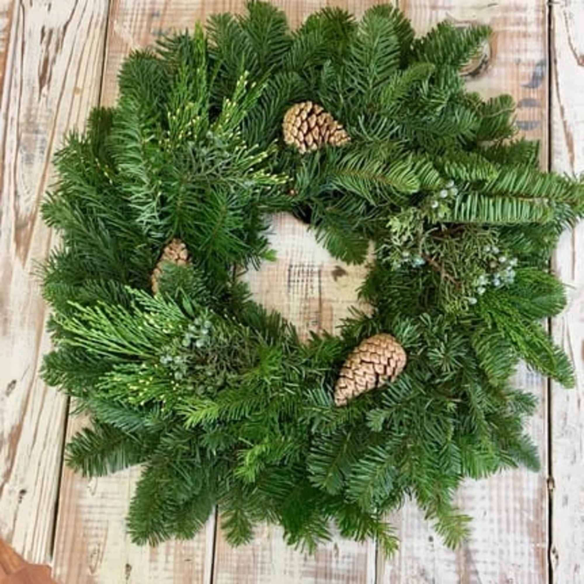 Evoke warm Christmas memories on cold winter nights with this fresh wreath.