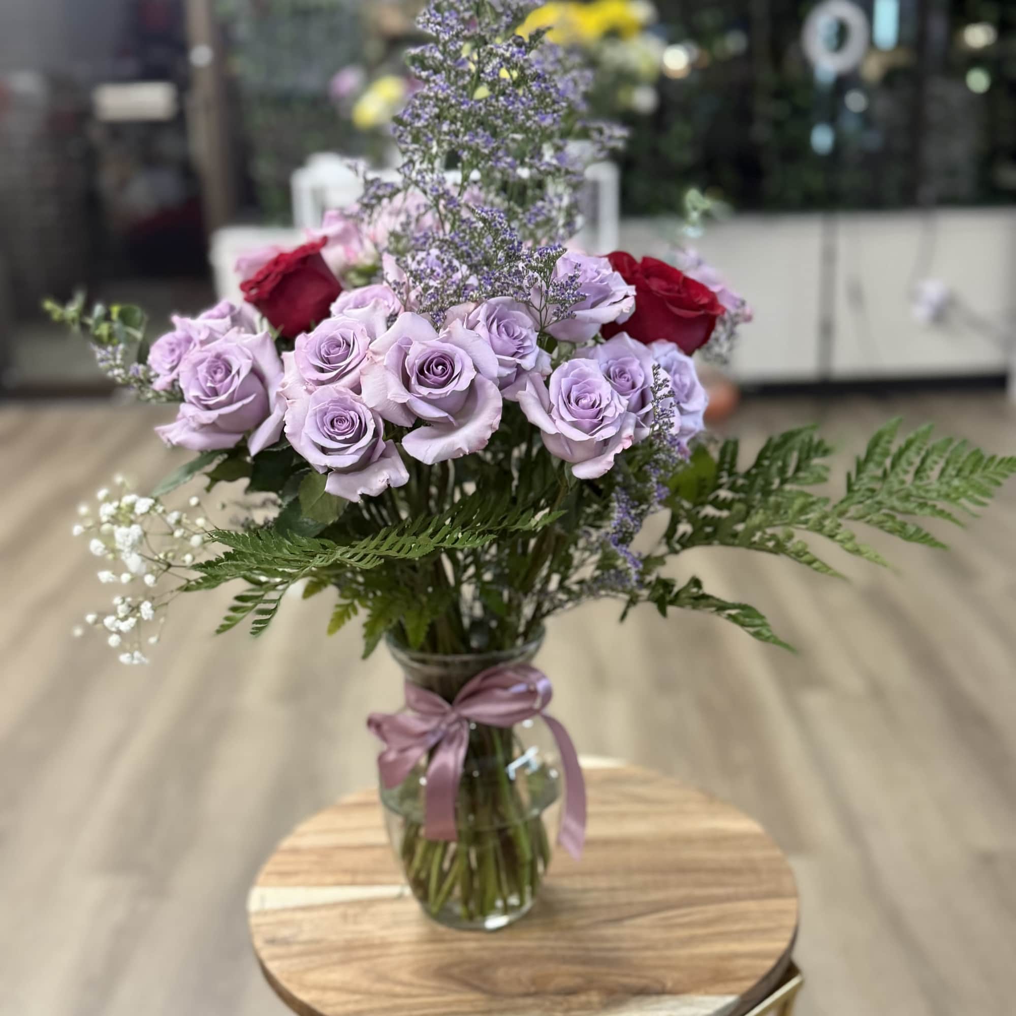 A graceful and romantic display featuring lavender roses arranged with delicate baby&rsquo;s