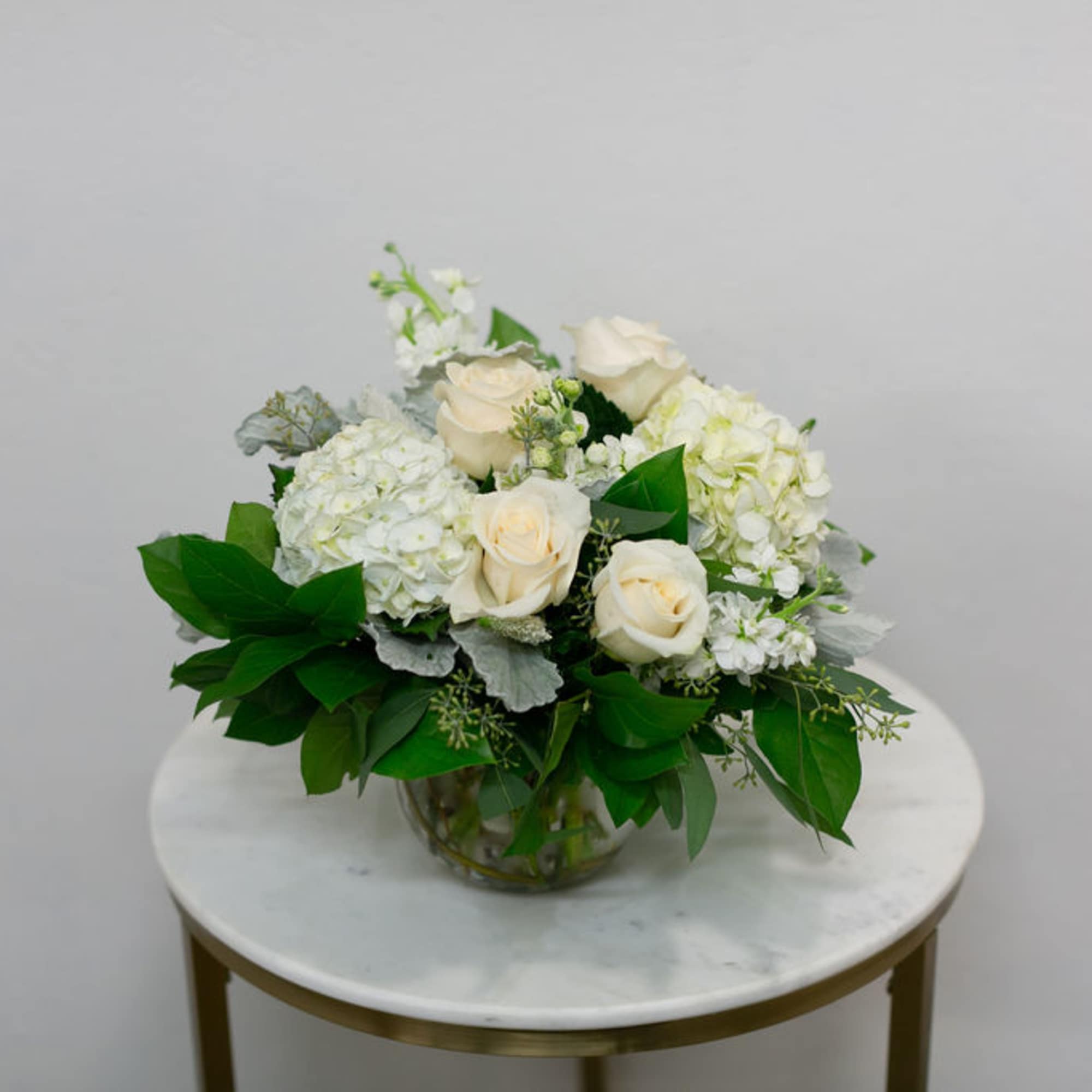 Desire a floral arrangement designed elegantly in a simple color palette? This