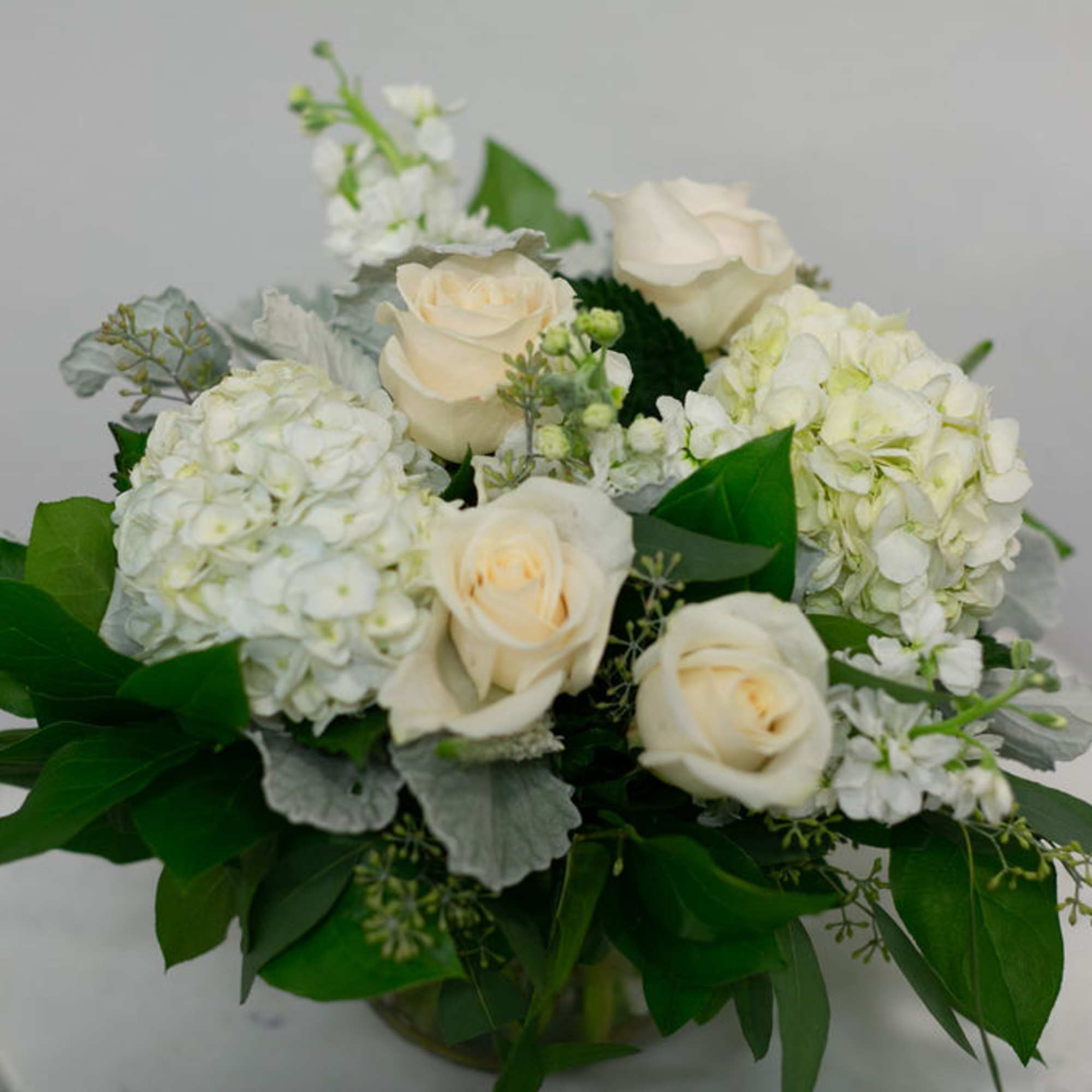 Desire a floral arrangement designed elegantly in a simple color palette? This