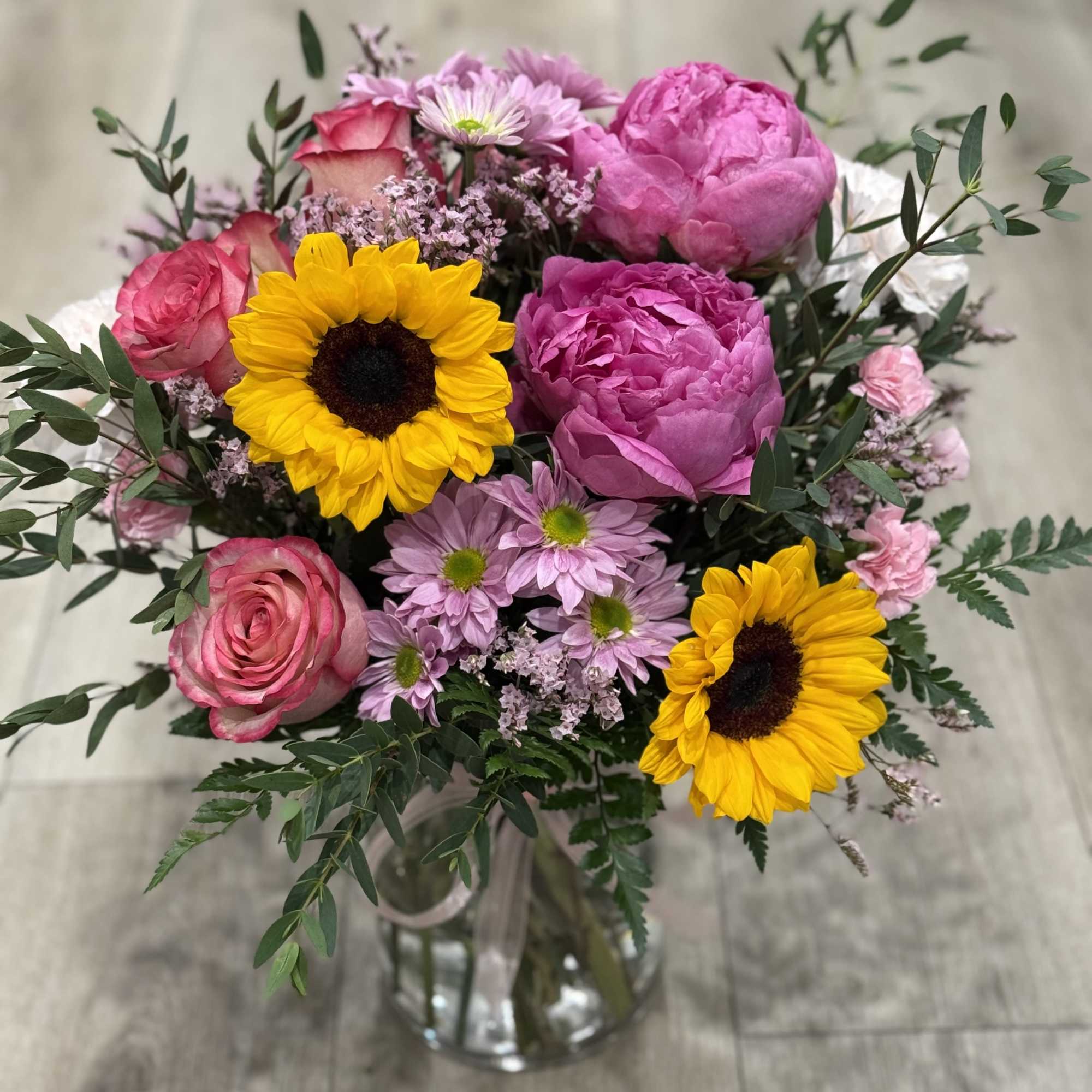 Arrangement includes peonies, roses, carnations and daisies

Celebrate your loved one with a