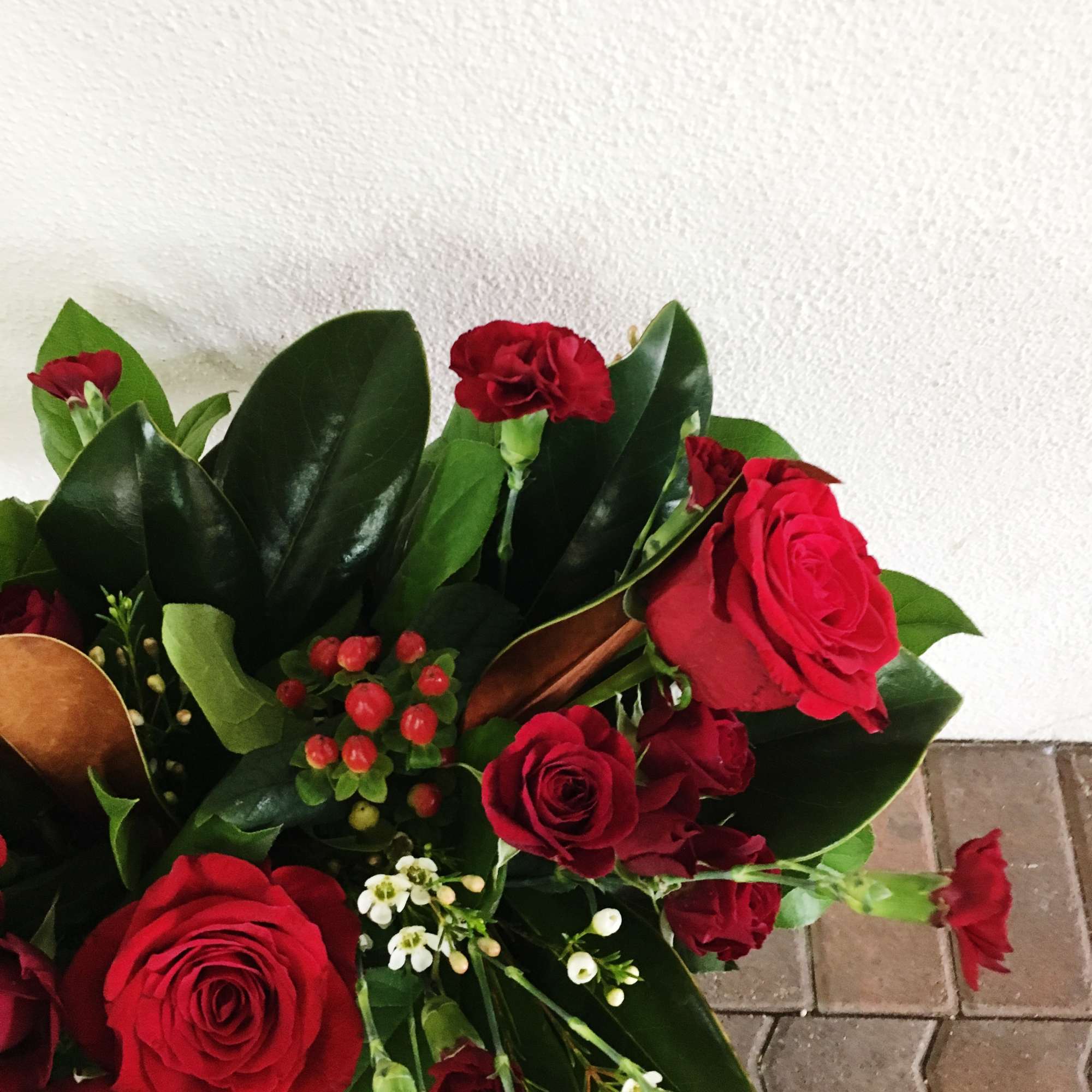 Your traditional centerpiece for the holidays with gorgeous reds and holiday foliage