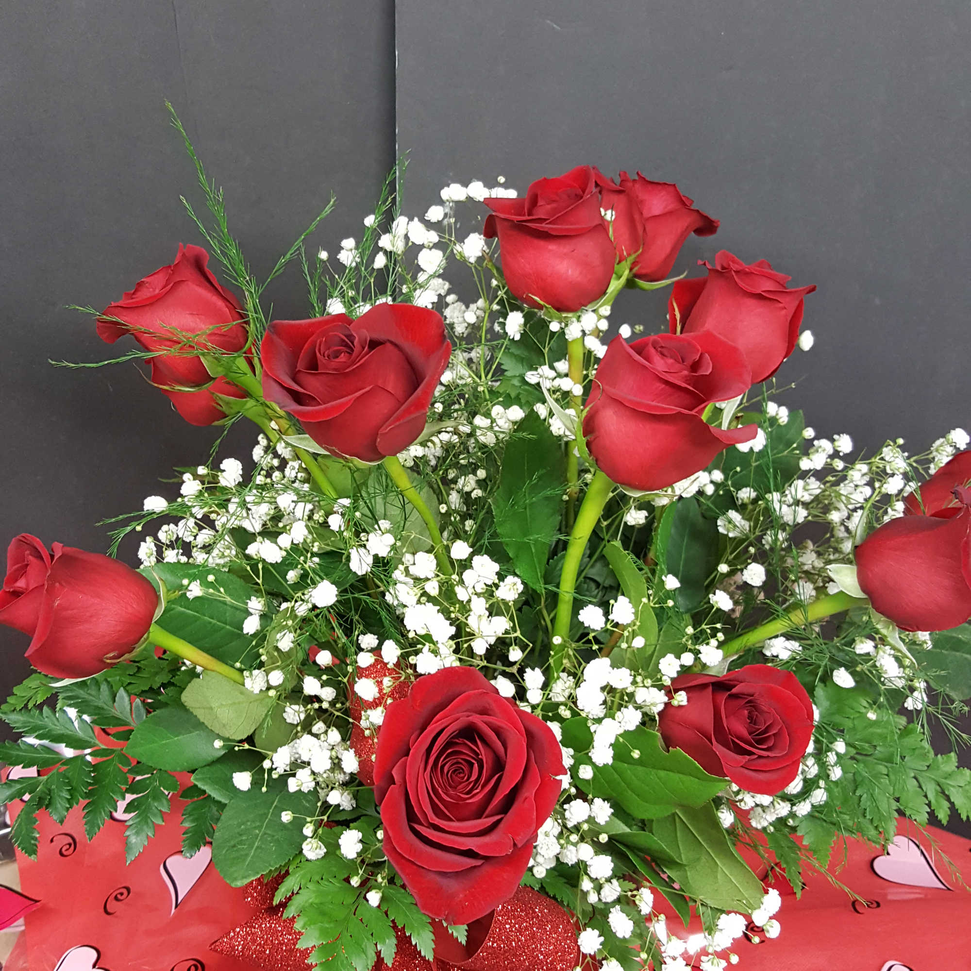 Eye catching design of one dozen 40-50cm Freedom red roses. Smaller head/bloom