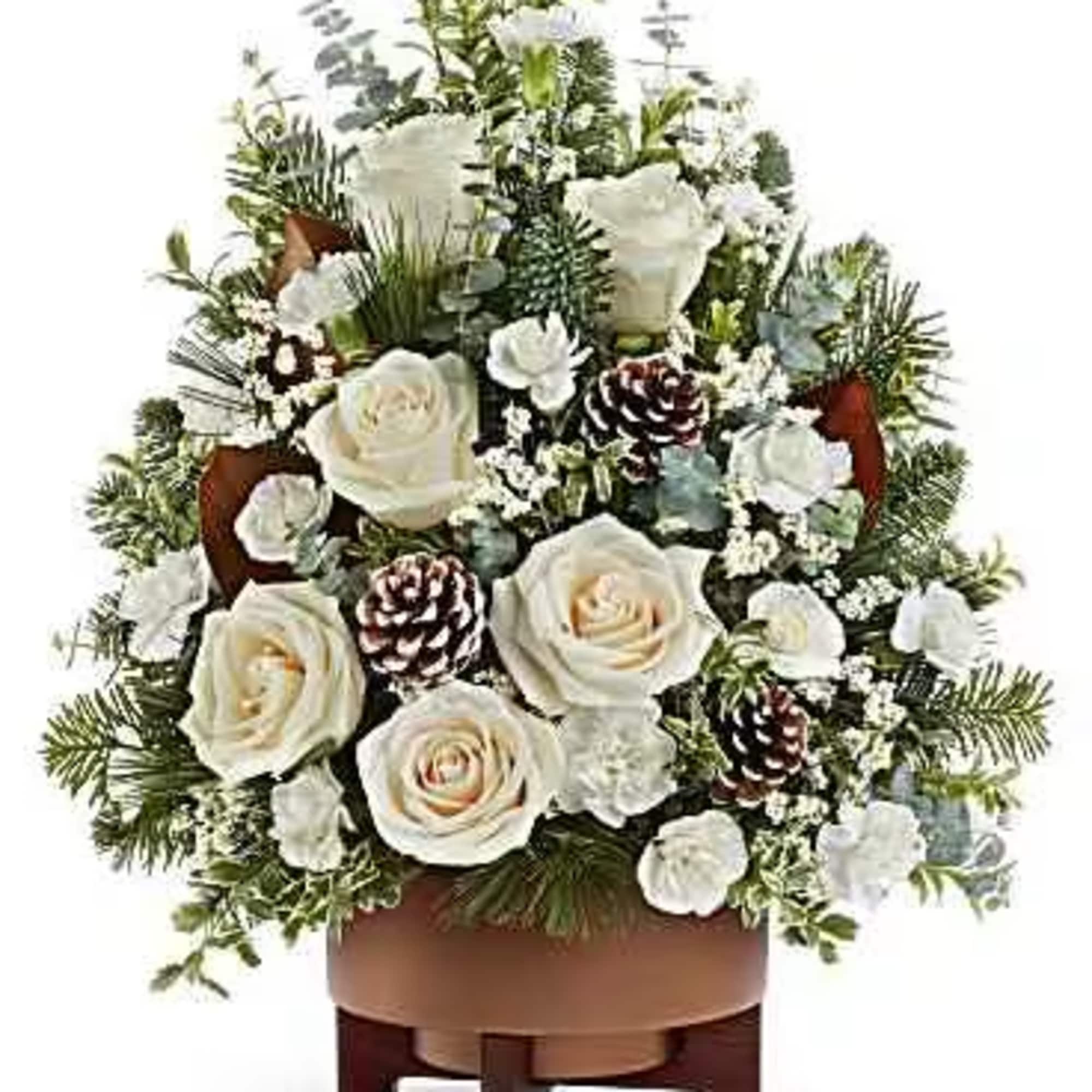 Alpine Snow Tree glows with white roses, winter greens, and pinecones in