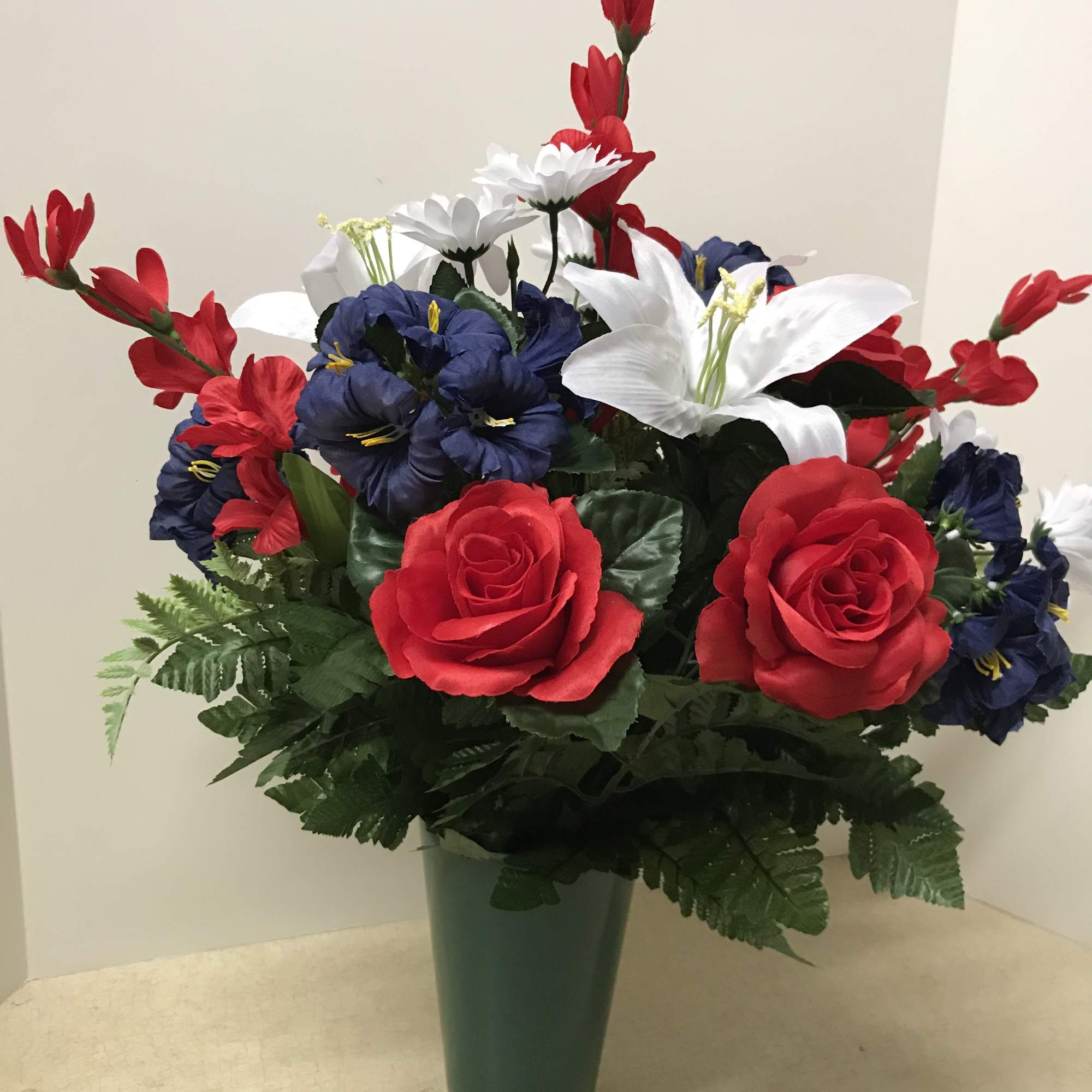 This memorial arrangement is fixed on styrofoam and is designed to either