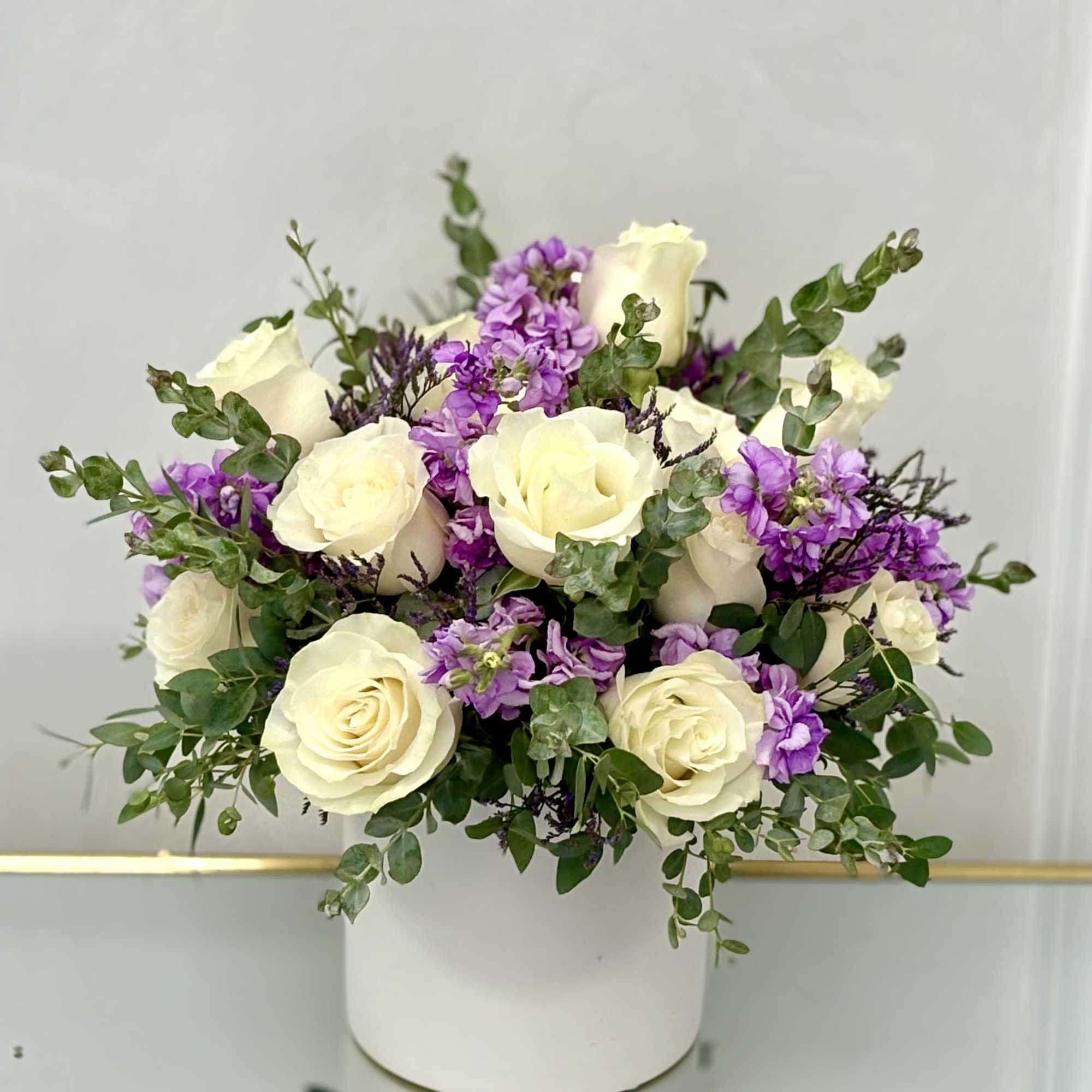 Soft, romantic, and full of charm, Lavender Mist features elegant ivory roses