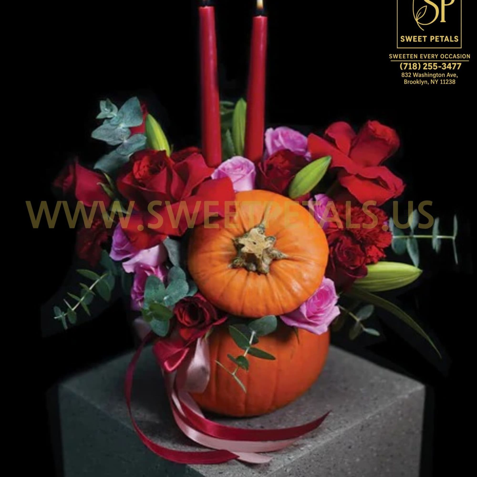 The Pumpkin Candlelight Floral Arrangement by SweetPetals captures the cozy spirit of