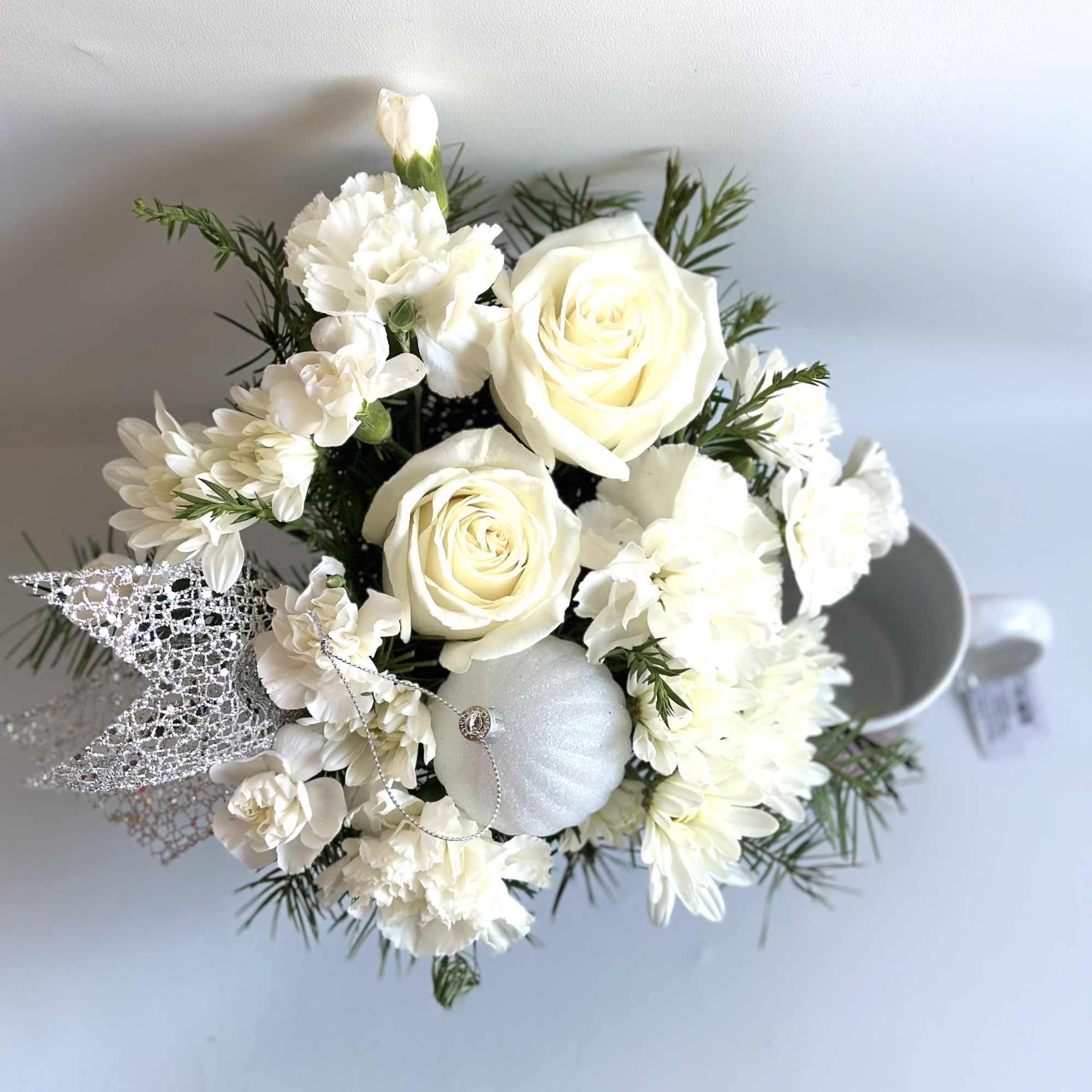 Perfect little keepsake a cup full of flowers. Done in all white.