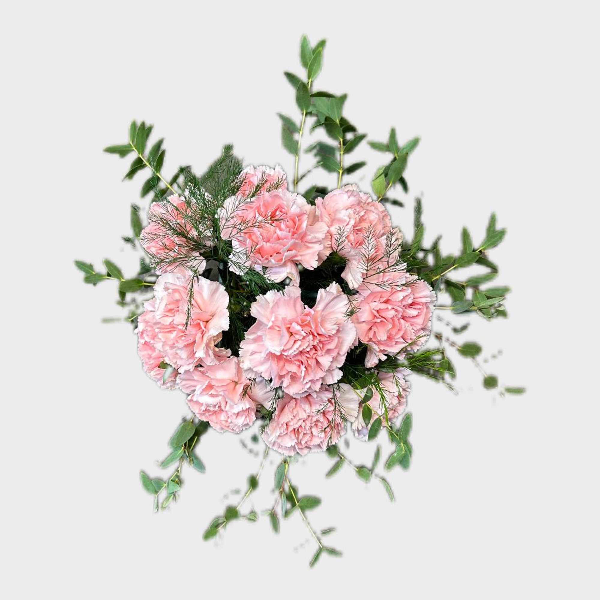 A dozen carnations designed in a cube vase among lush eucalyptus greenery.