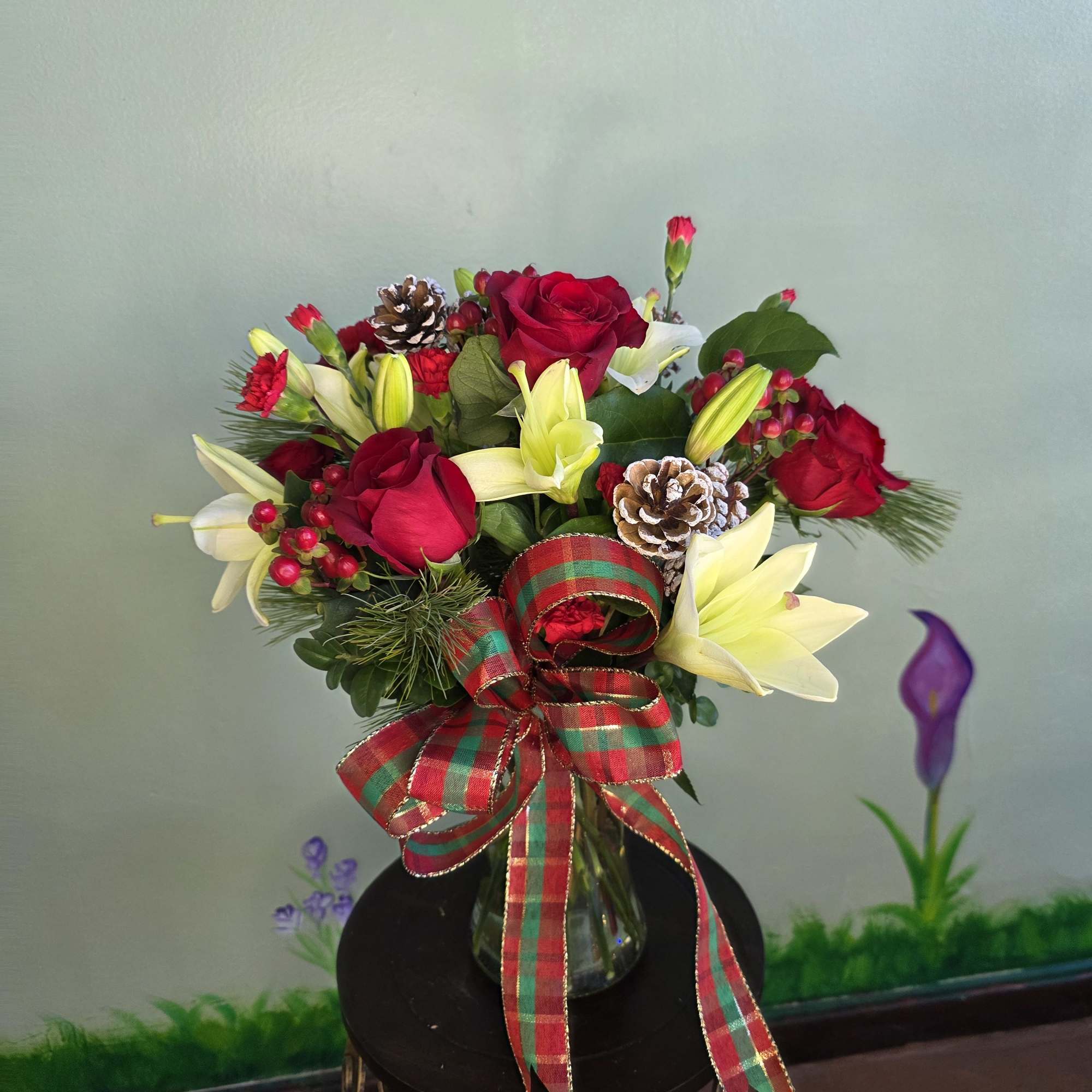 Winter Rose Celebration is a festive and elegant holiday arrangement featuring rich