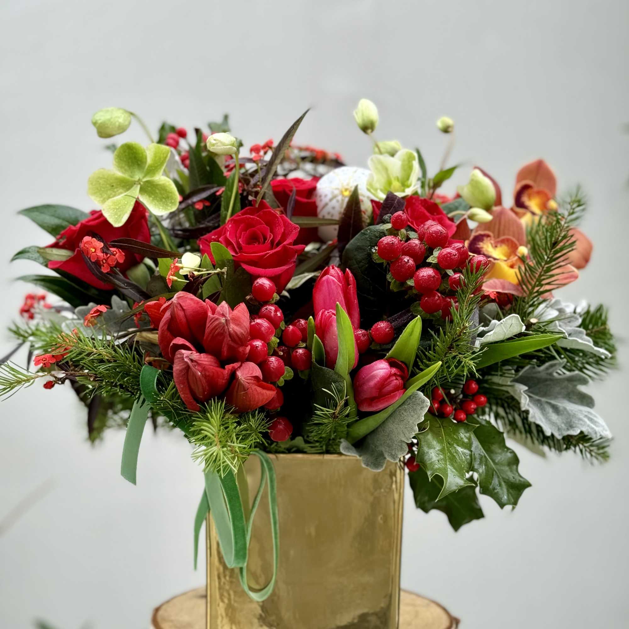 A gorgeous design filled with seasonal greens, Amaryllis , roses, tulips and