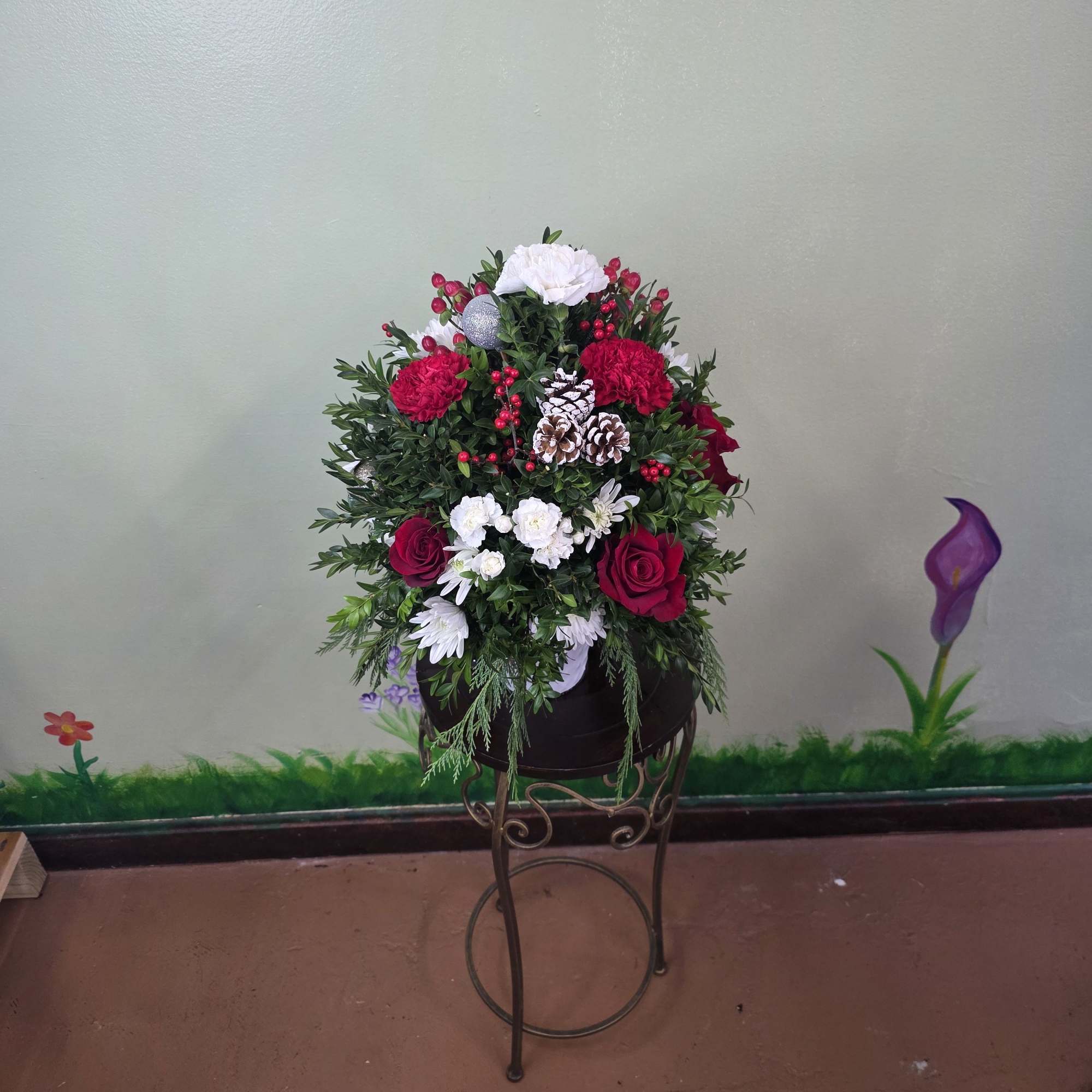 Christmas Cheer Garden is a lush and joyful holiday arrangement featuring vibrant