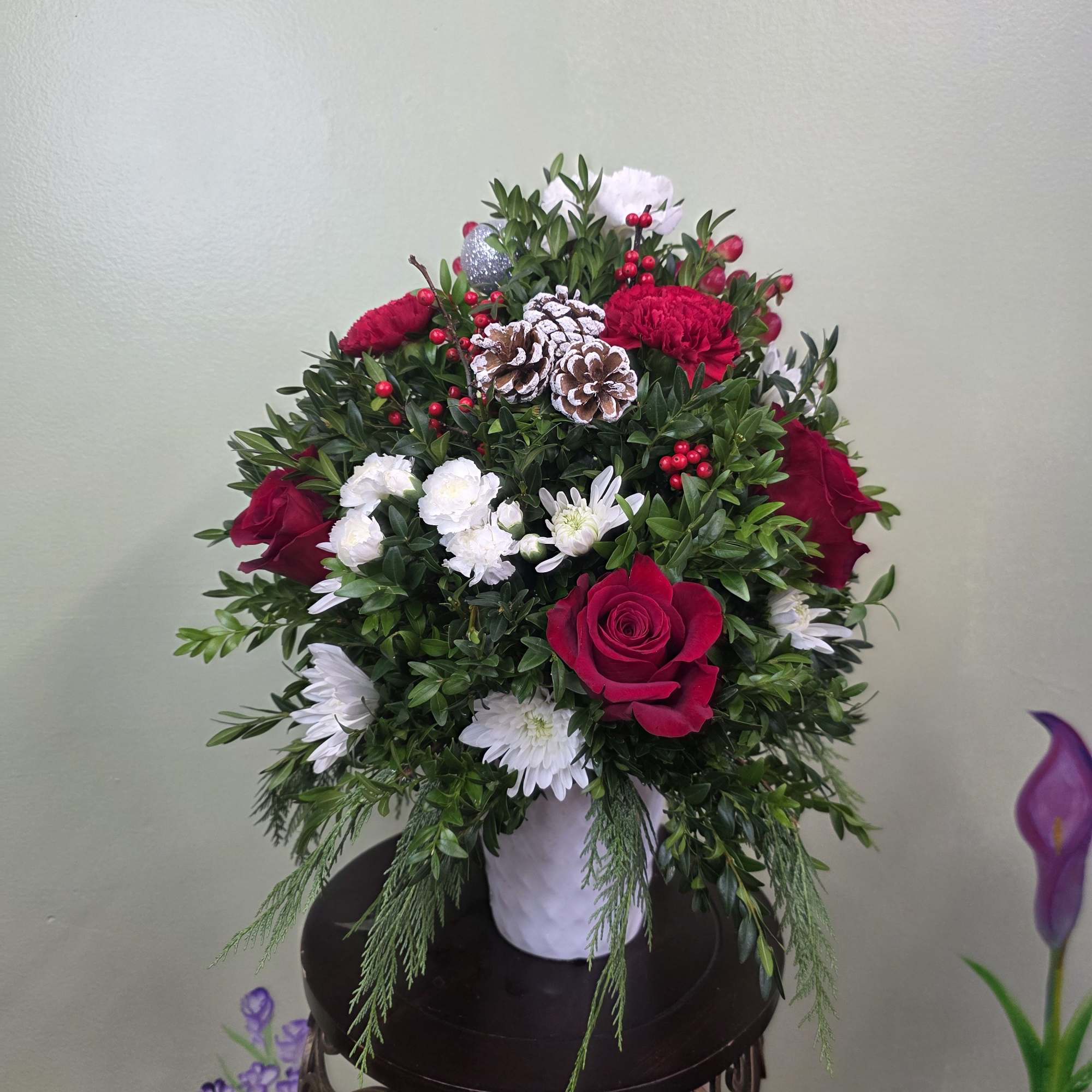Christmas Cheer Garden is a lush and joyful holiday arrangement featuring vibrant