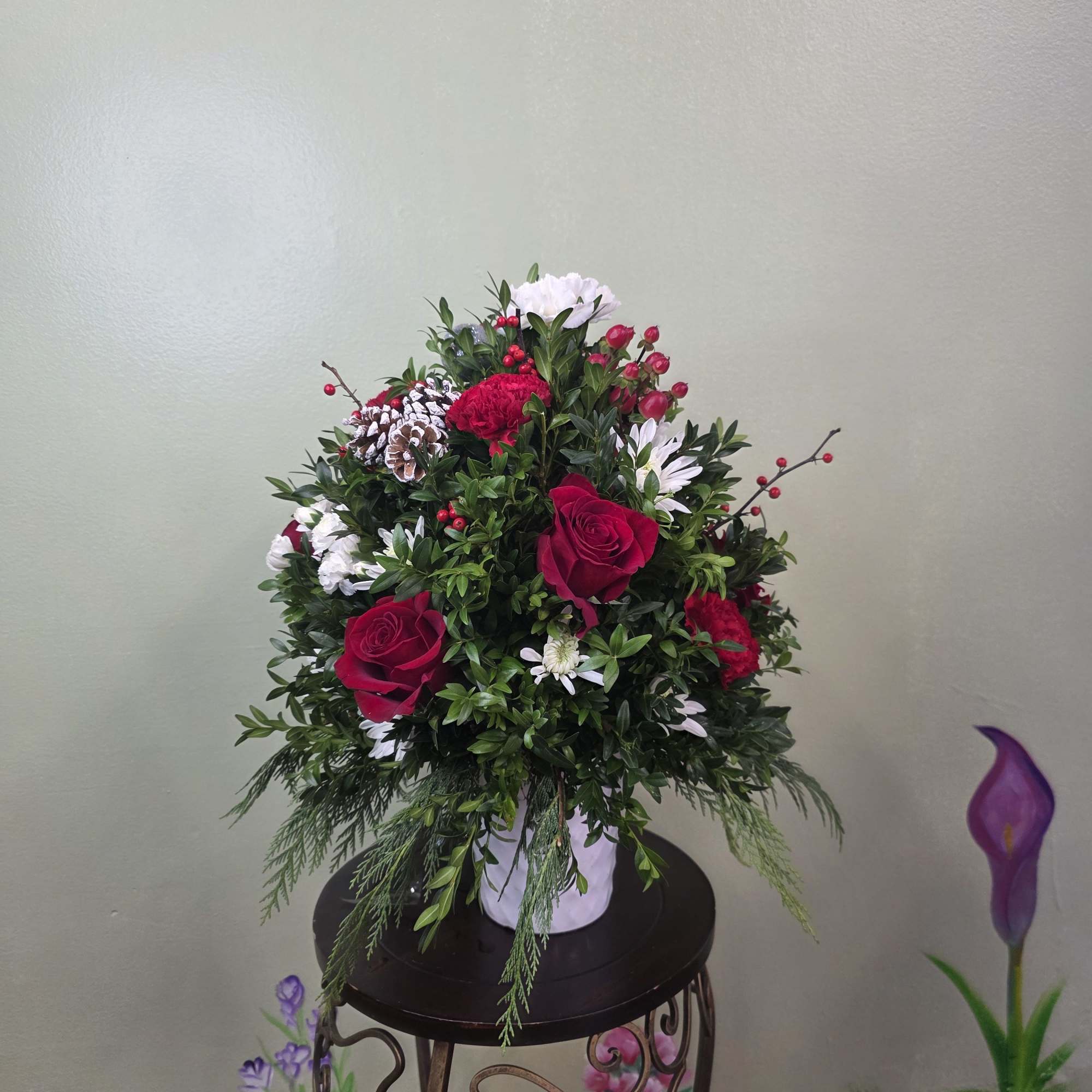 Christmas Cheer Garden is a lush and joyful holiday arrangement featuring vibrant
