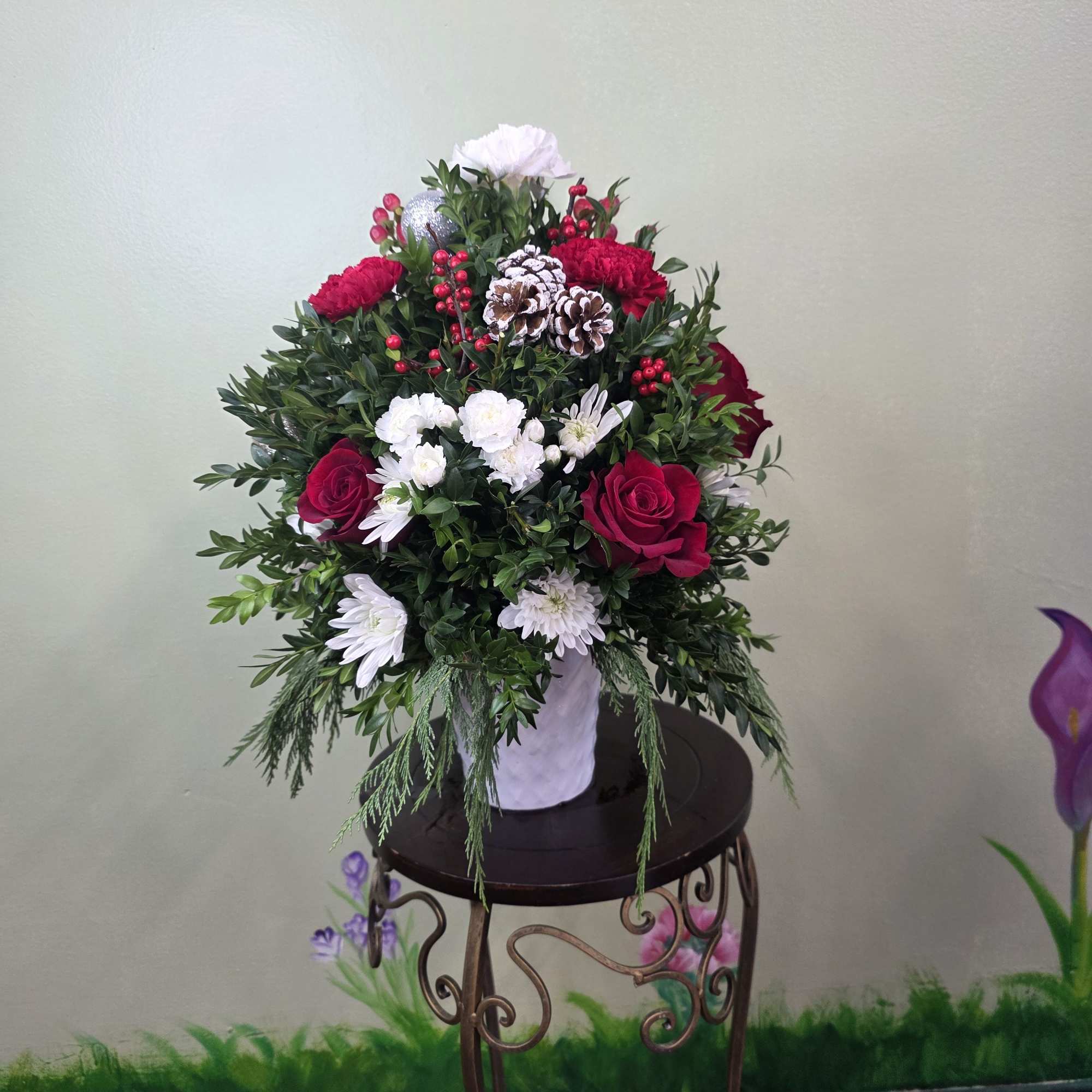 Christmas Cheer Garden is a lush and joyful holiday arrangement featuring vibrant