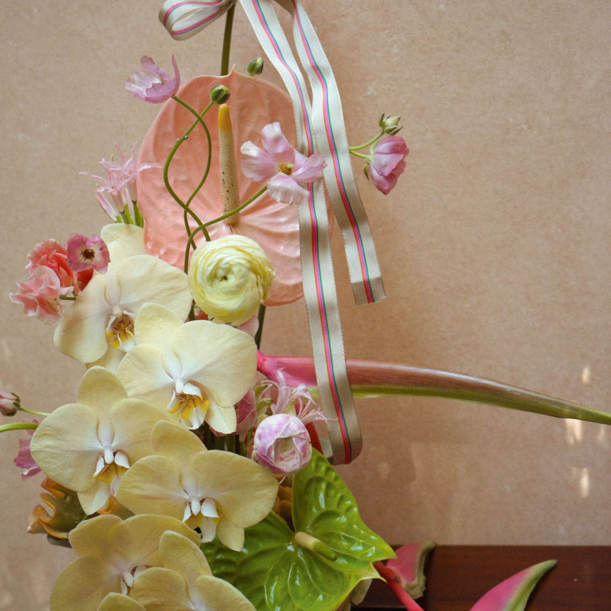 A unique escape into color and texture, this tropical arrangement brings warmth