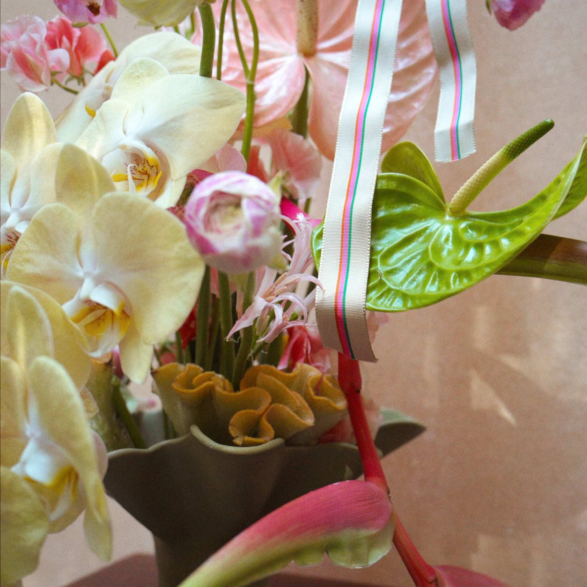 A unique escape into color and texture, this tropical arrangement brings warmth