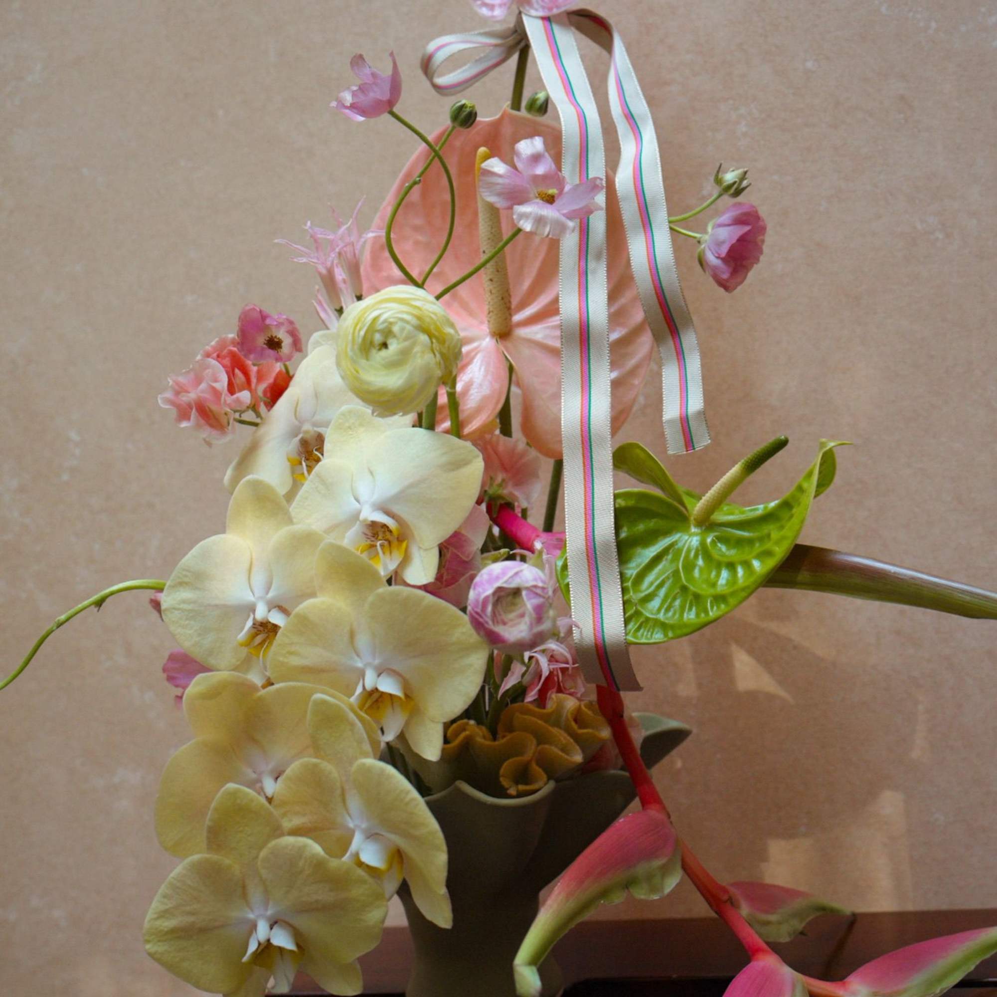 A unique escape into color and texture, this tropical arrangement brings warmth