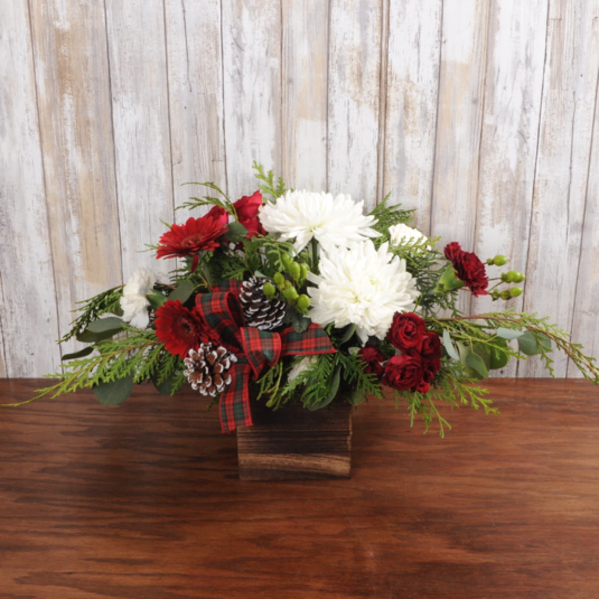 Woodsy holiday charm fills this cute tabletop wood box complete with evergreens