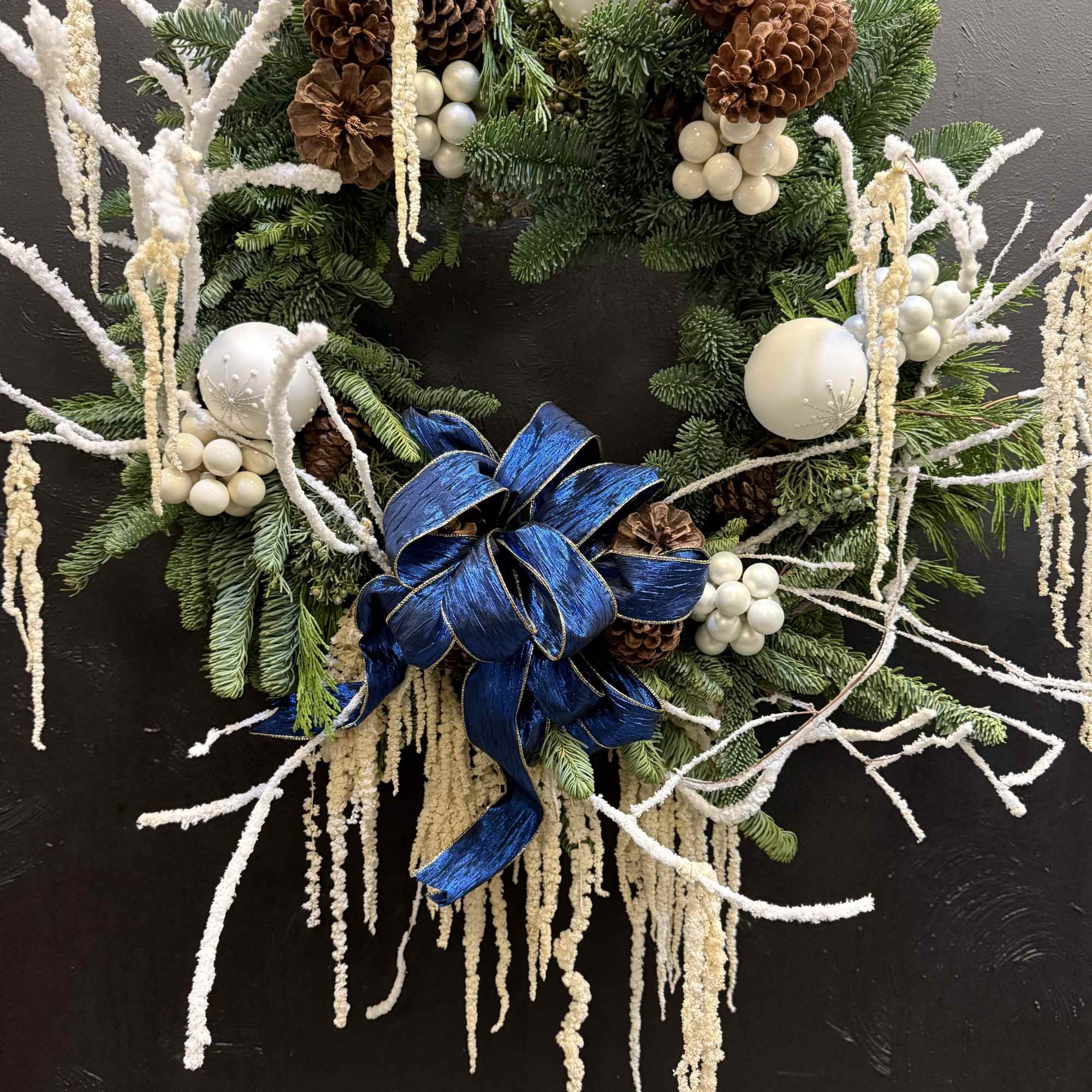 The Winter Pearl Elegance Wreath is a fresh, handcrafted Christmas wreath made