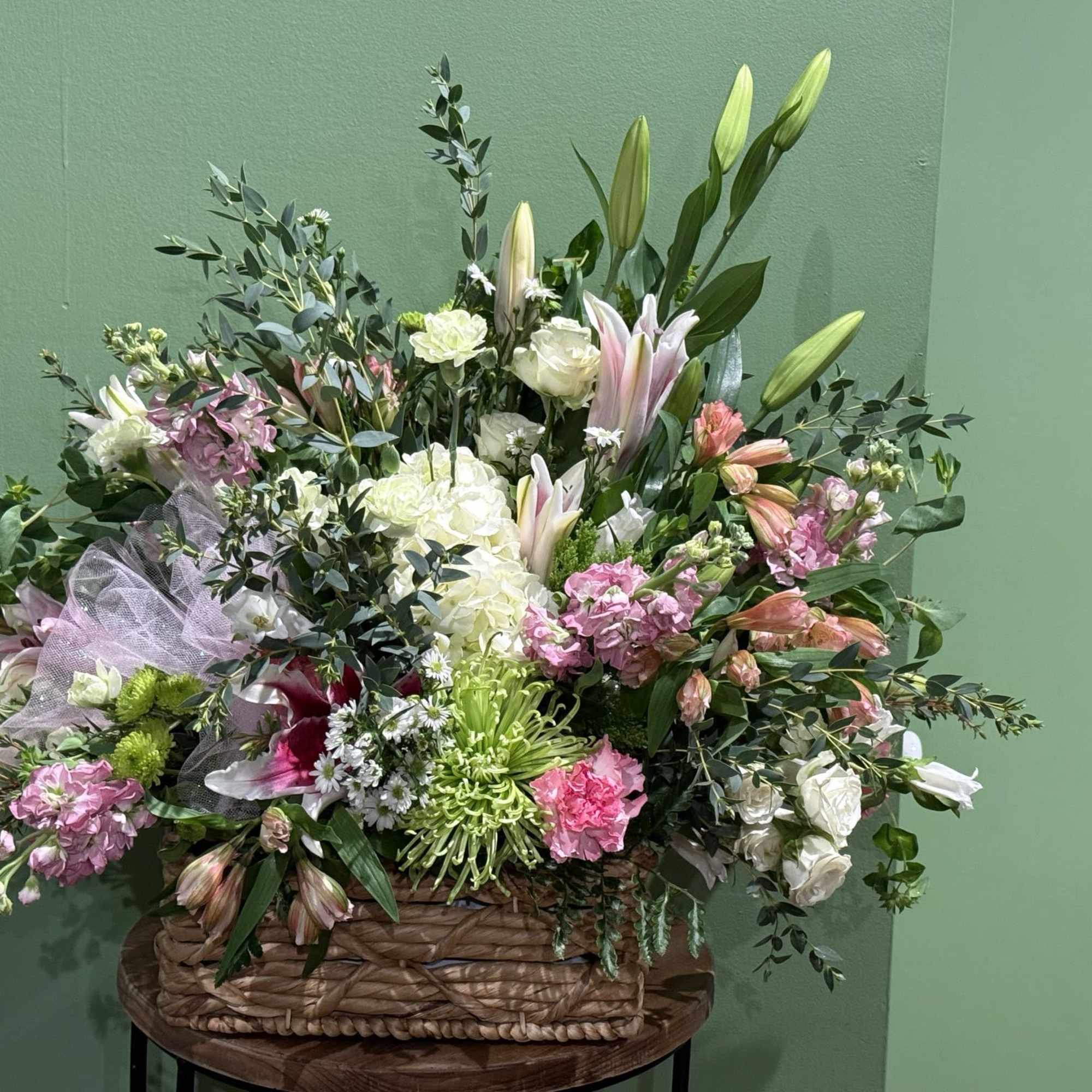 This arrangement brings a rustic feeling with a willow basket base.
*Be aware