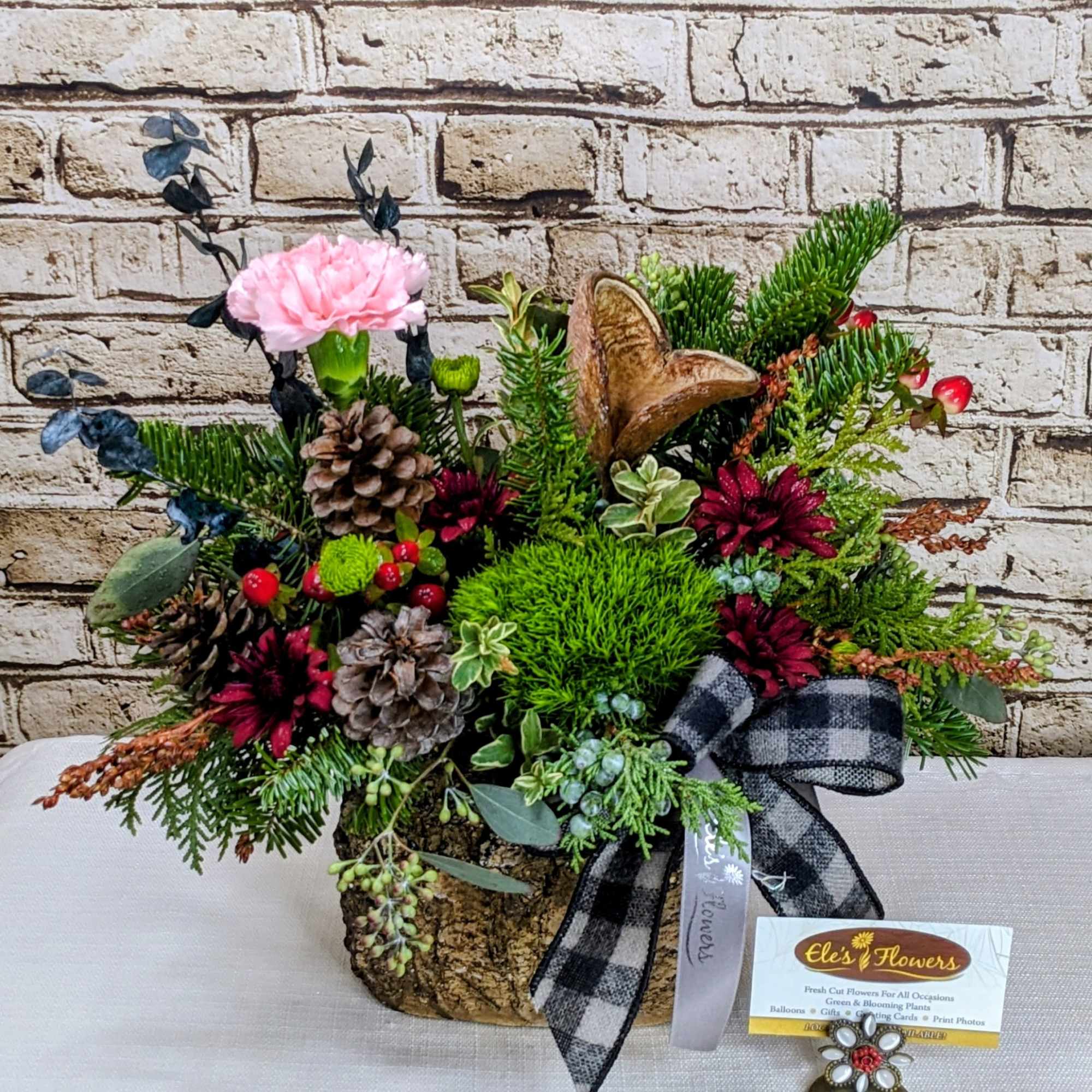 Our charming Country Christmas arrangement featuring a delightful blend of burgundy, green