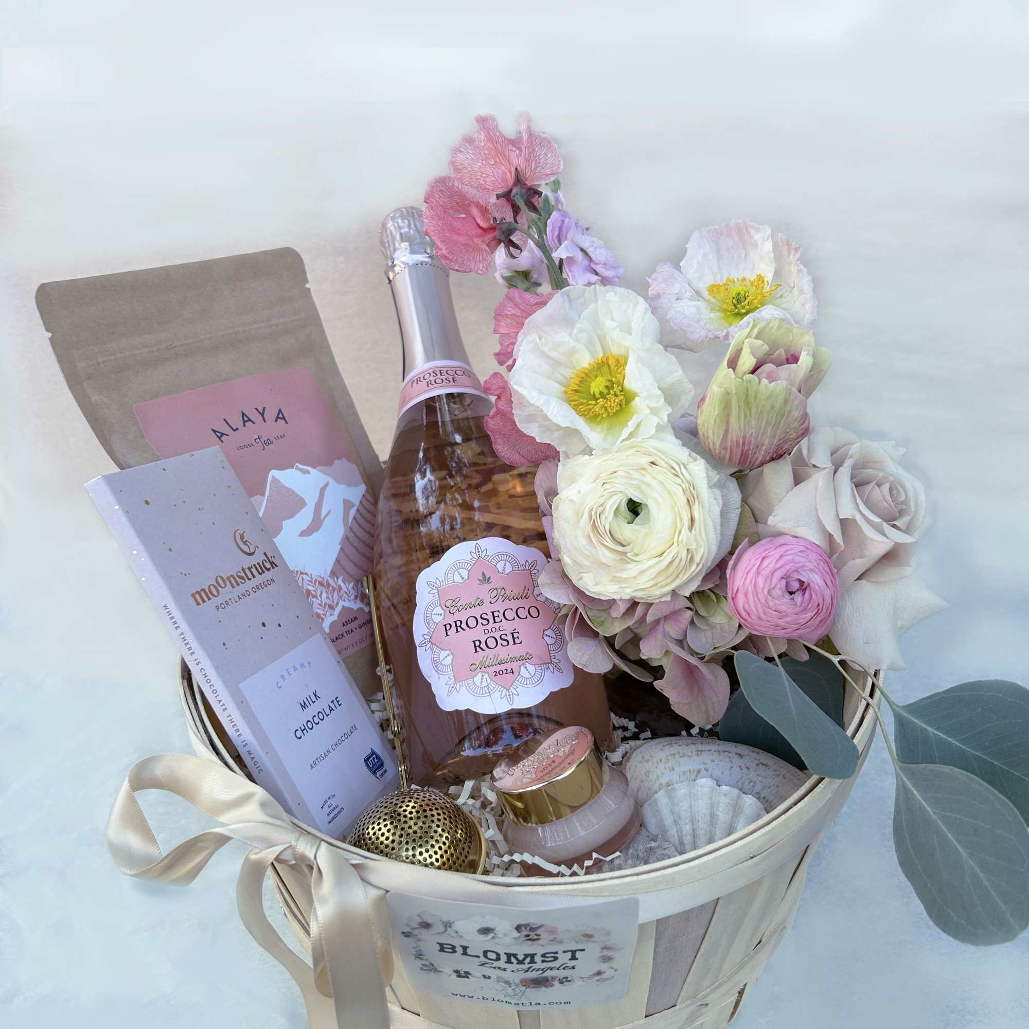 A celebration box with bubbly, chocolate, fresh flowers and a Liberty x