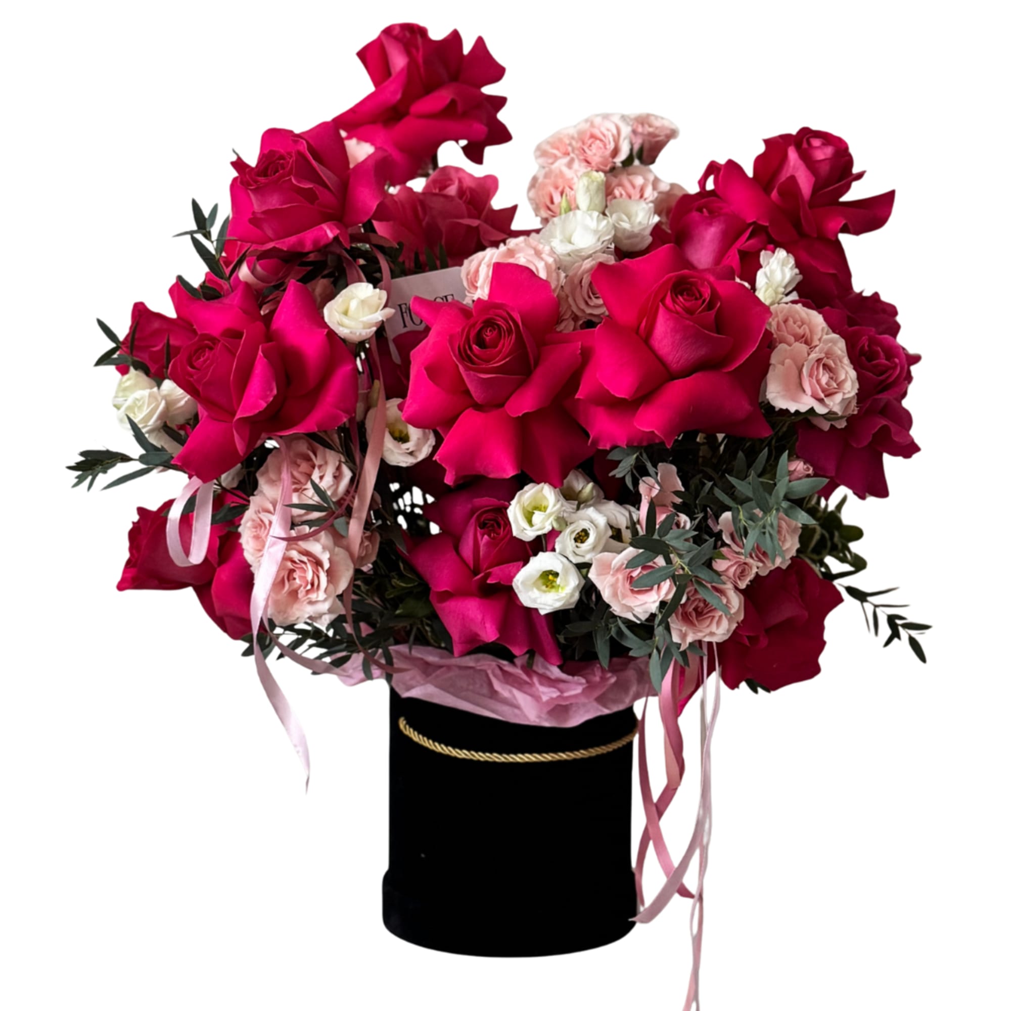 A bold, glam hatbox arrangement packed with hot pink roses, soft blush