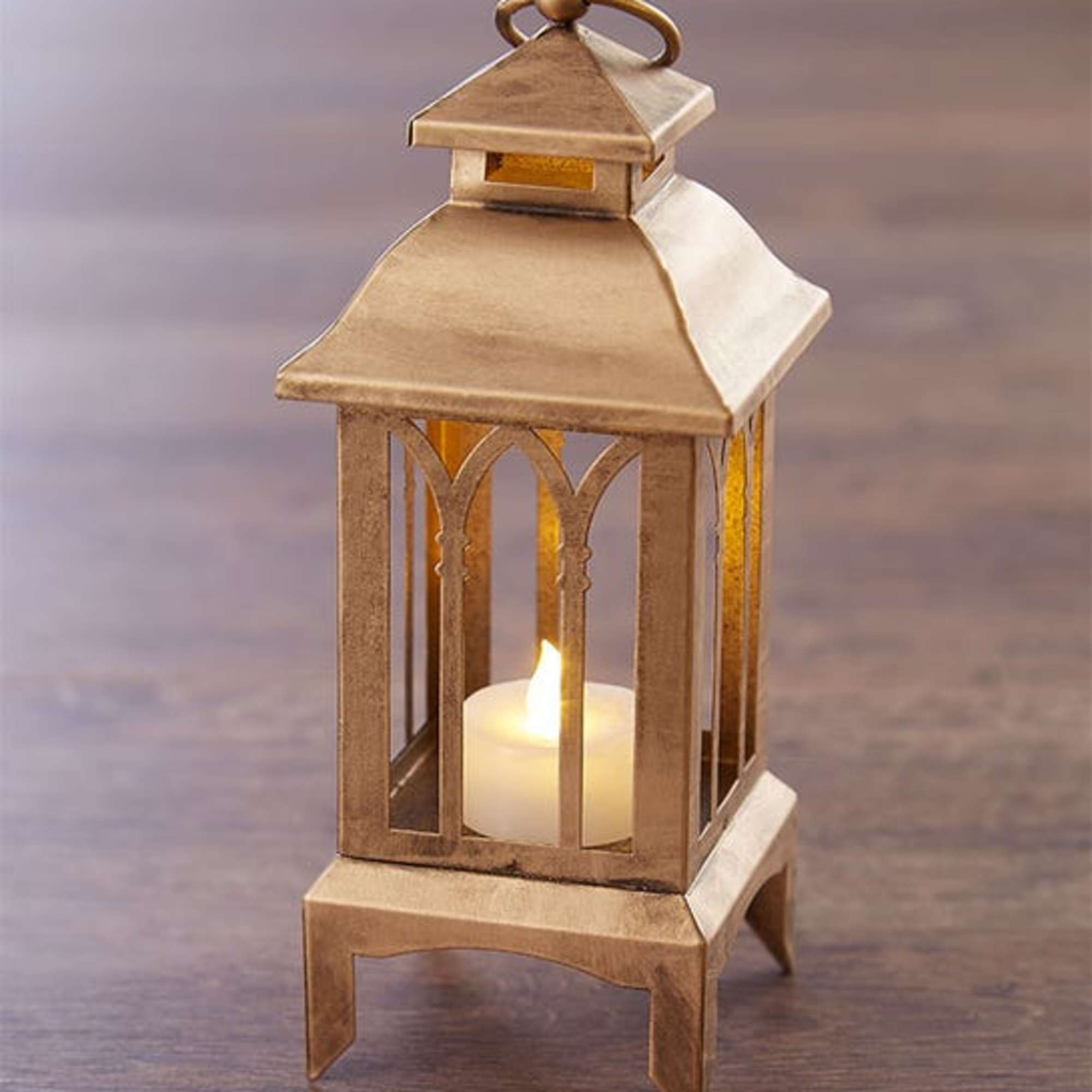 Our unique Christmas centerpiece features an elegant, antique gold vintage lantern with