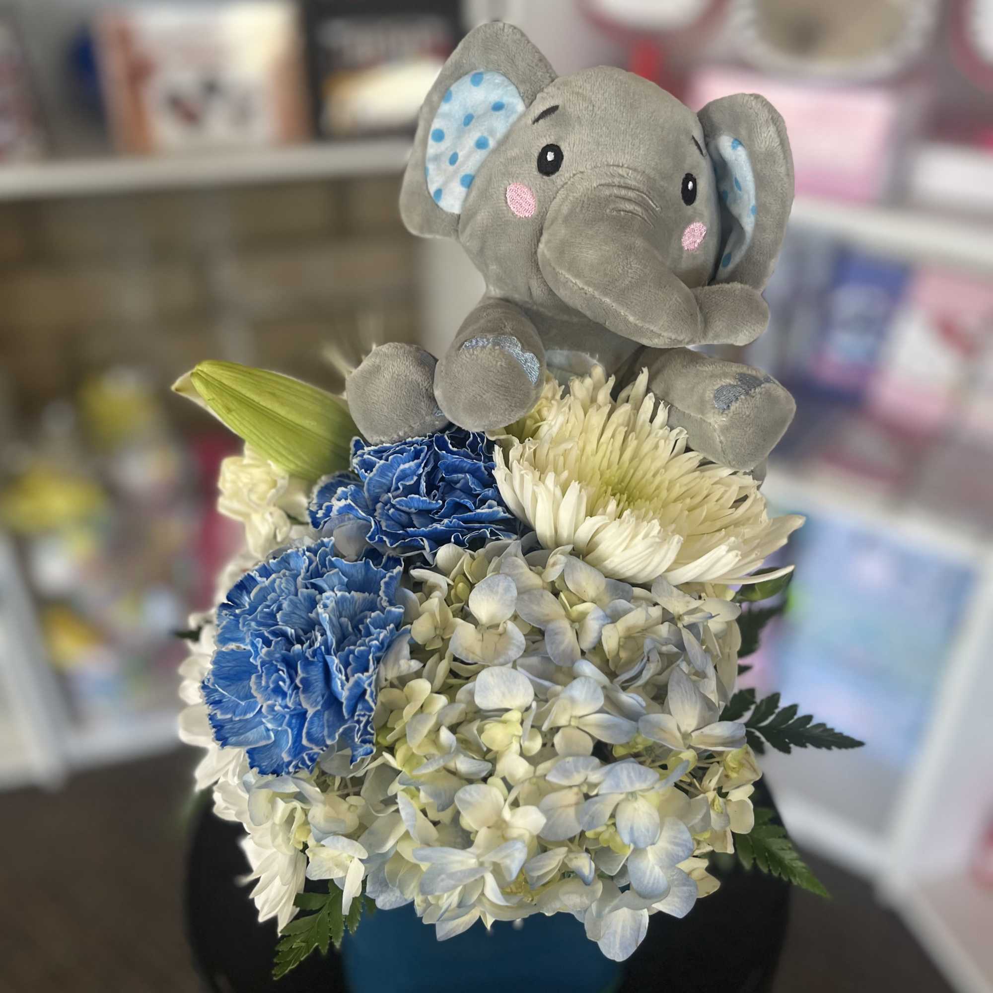fresh white and blue flowers with elephant plush 