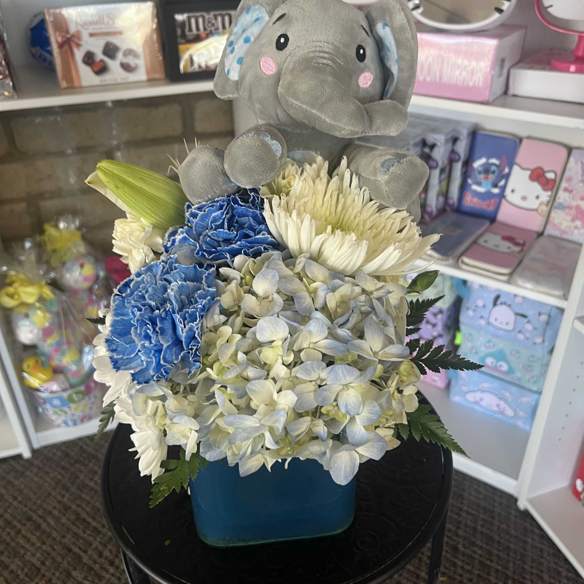 fresh white and blue flowers with elephant plush 