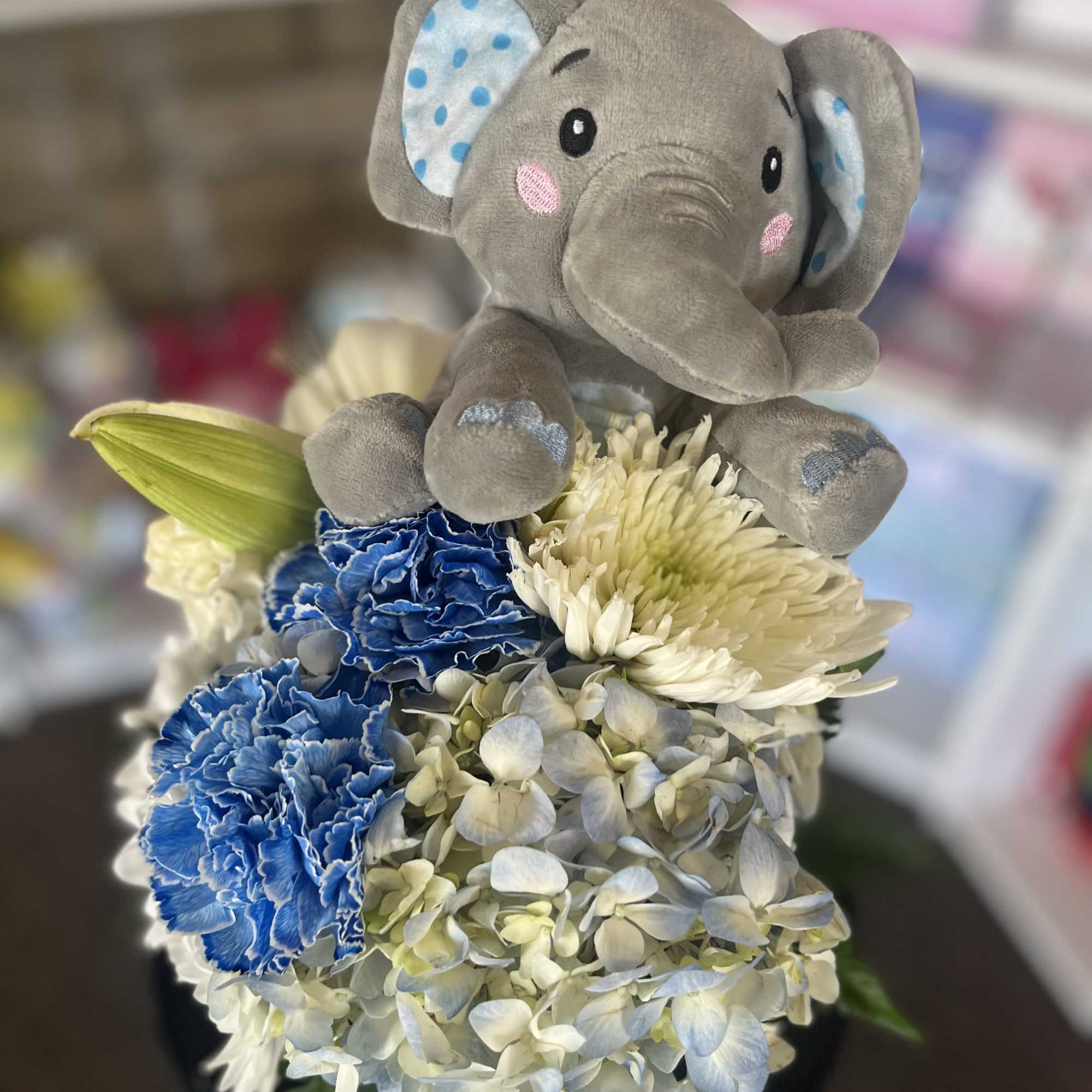 fresh white and blue flowers with elephant plush 