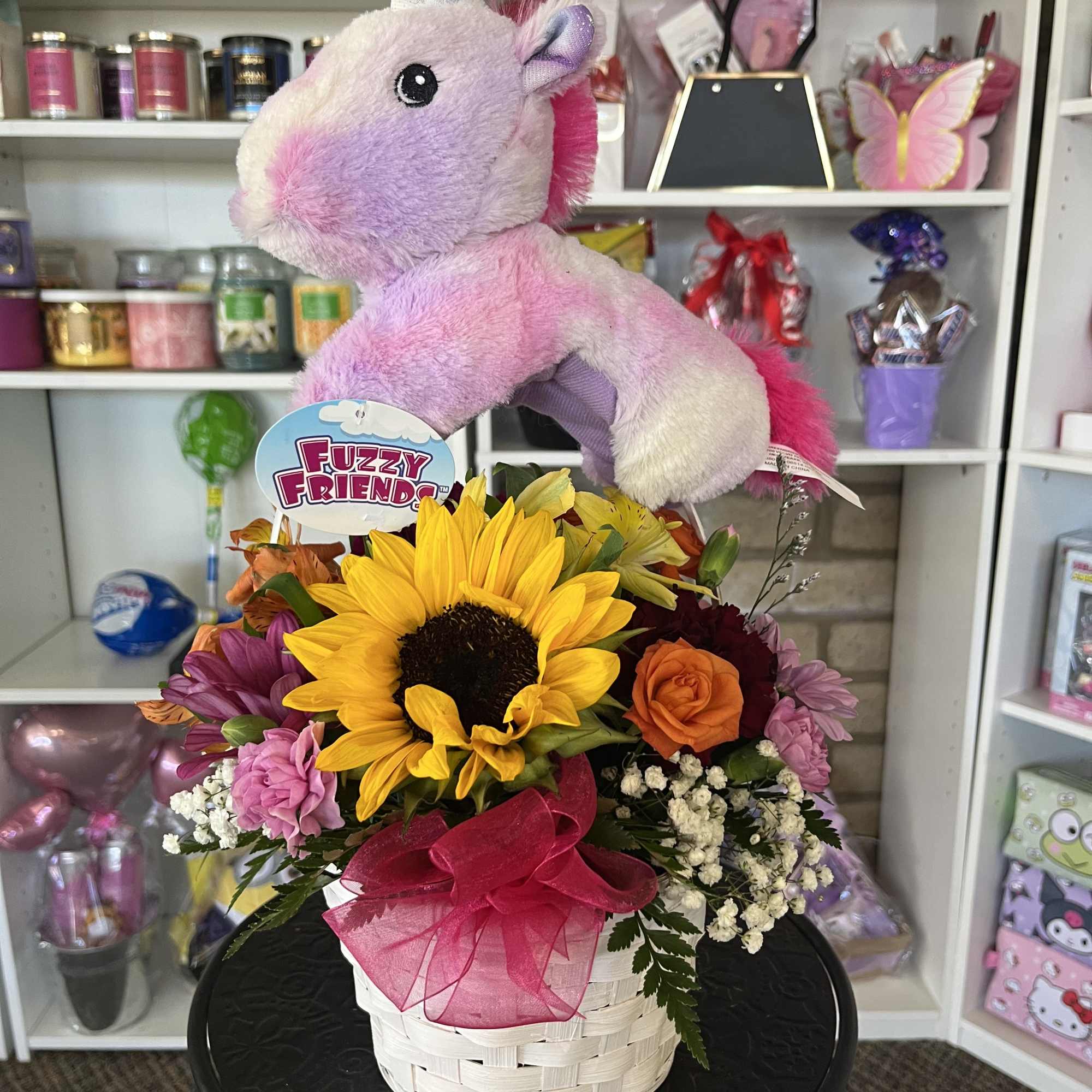 fresh flowers in basket with unicorn plush 