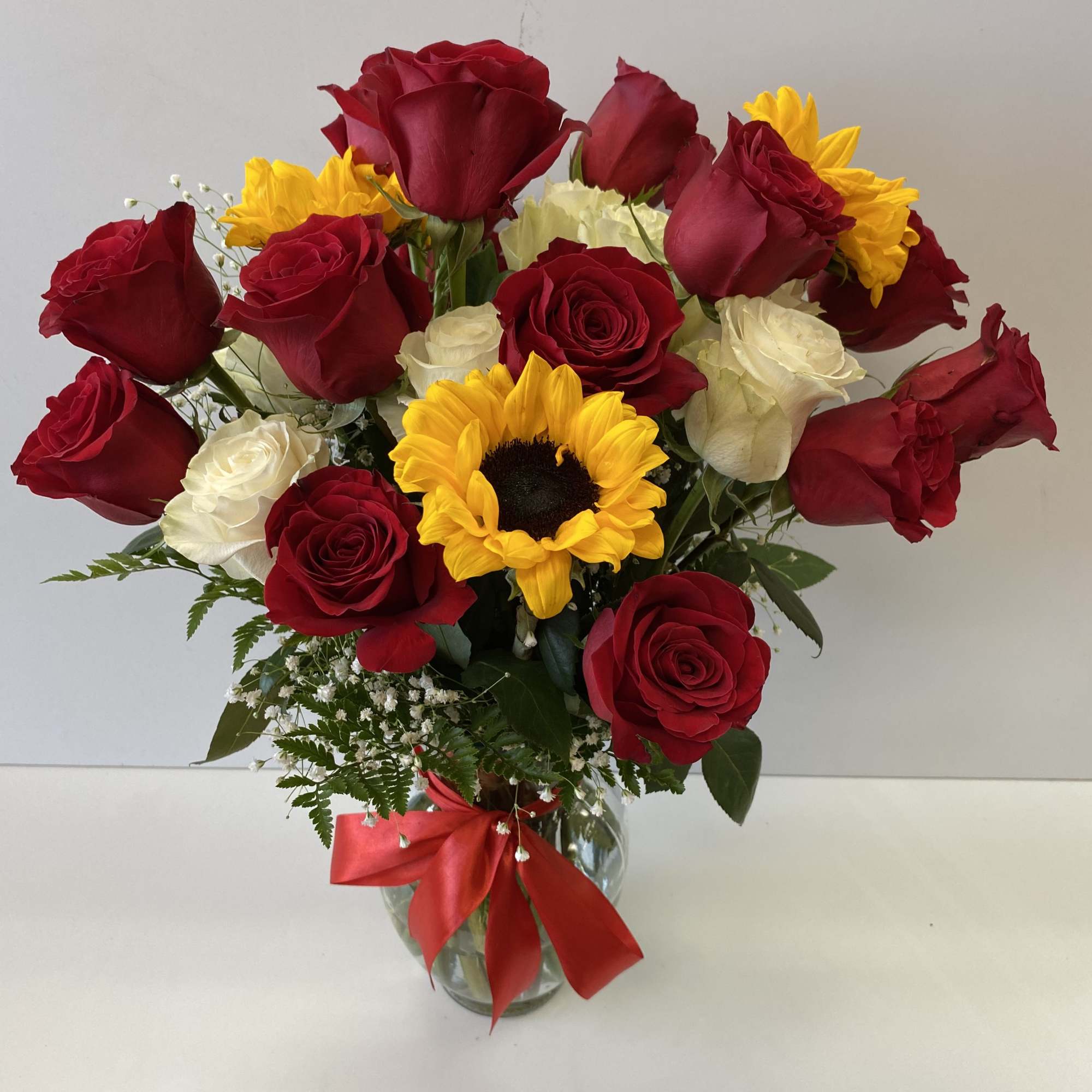 14 Red Roses, 6 white roses, 3 Sunflowers, with baby breath and