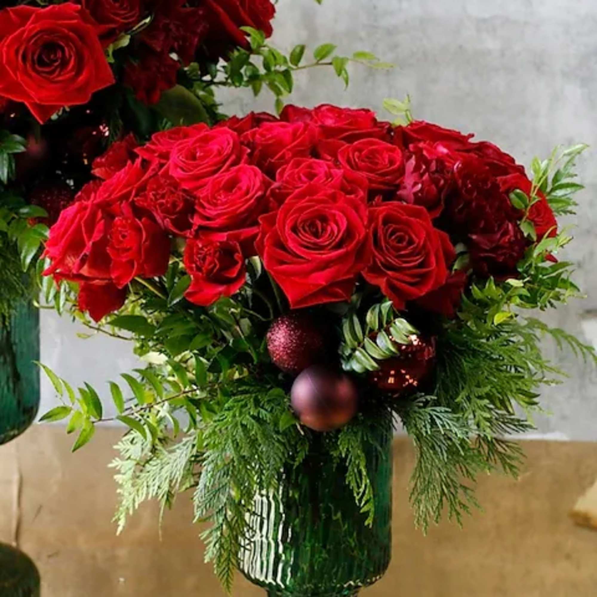 Vibrant Red roses and Shooting Star spray roses intertwine with lush huck