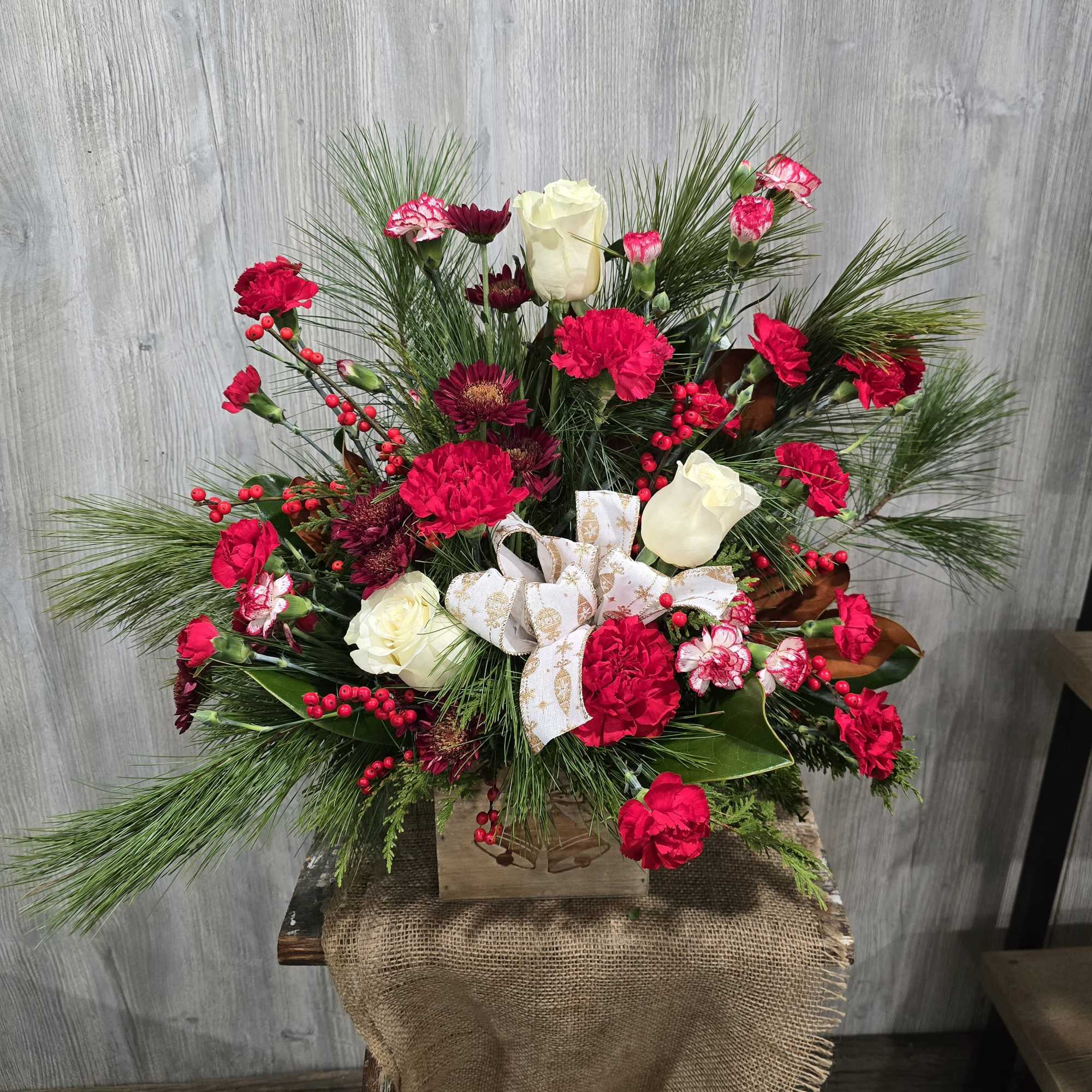 A beautiful wooden box with christmas bells on the front. Full of