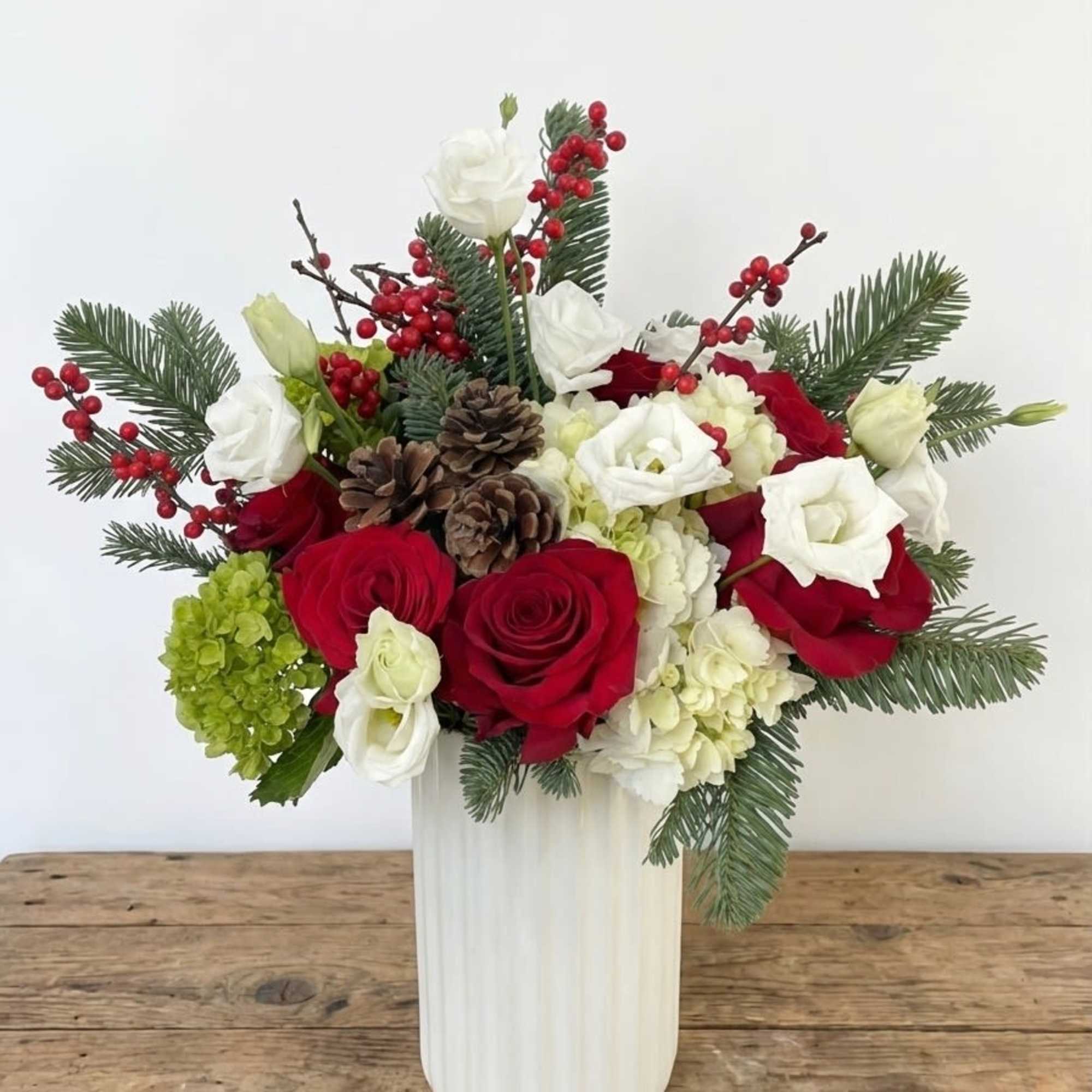 Elegant and festive, Holiday Aura is a timeless seasonal arrangement designed to