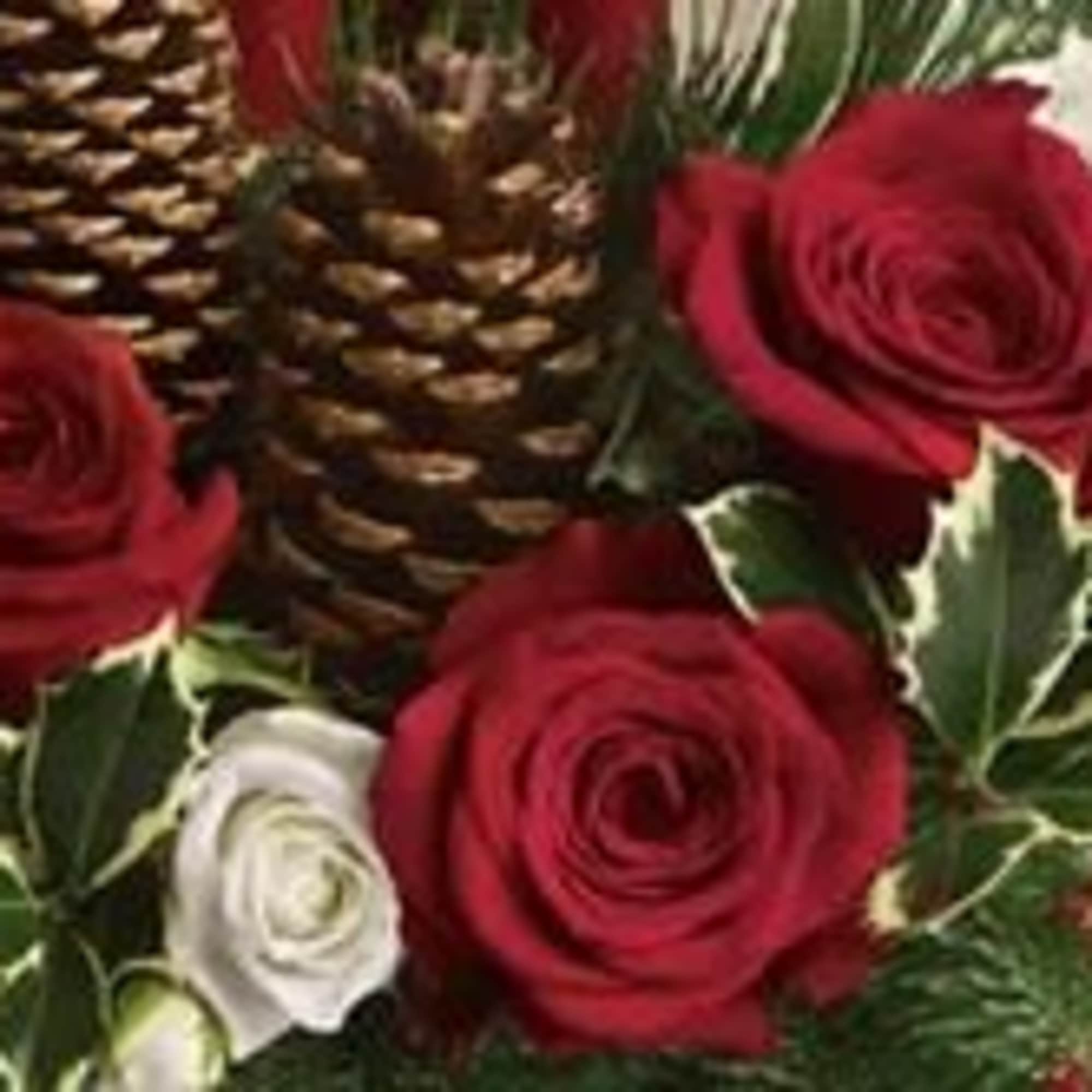 DESIGNERS MIX OF HOLIDAY GREENS, RED AND WHITE FLOWERS, BERRIES CONES ETC..
