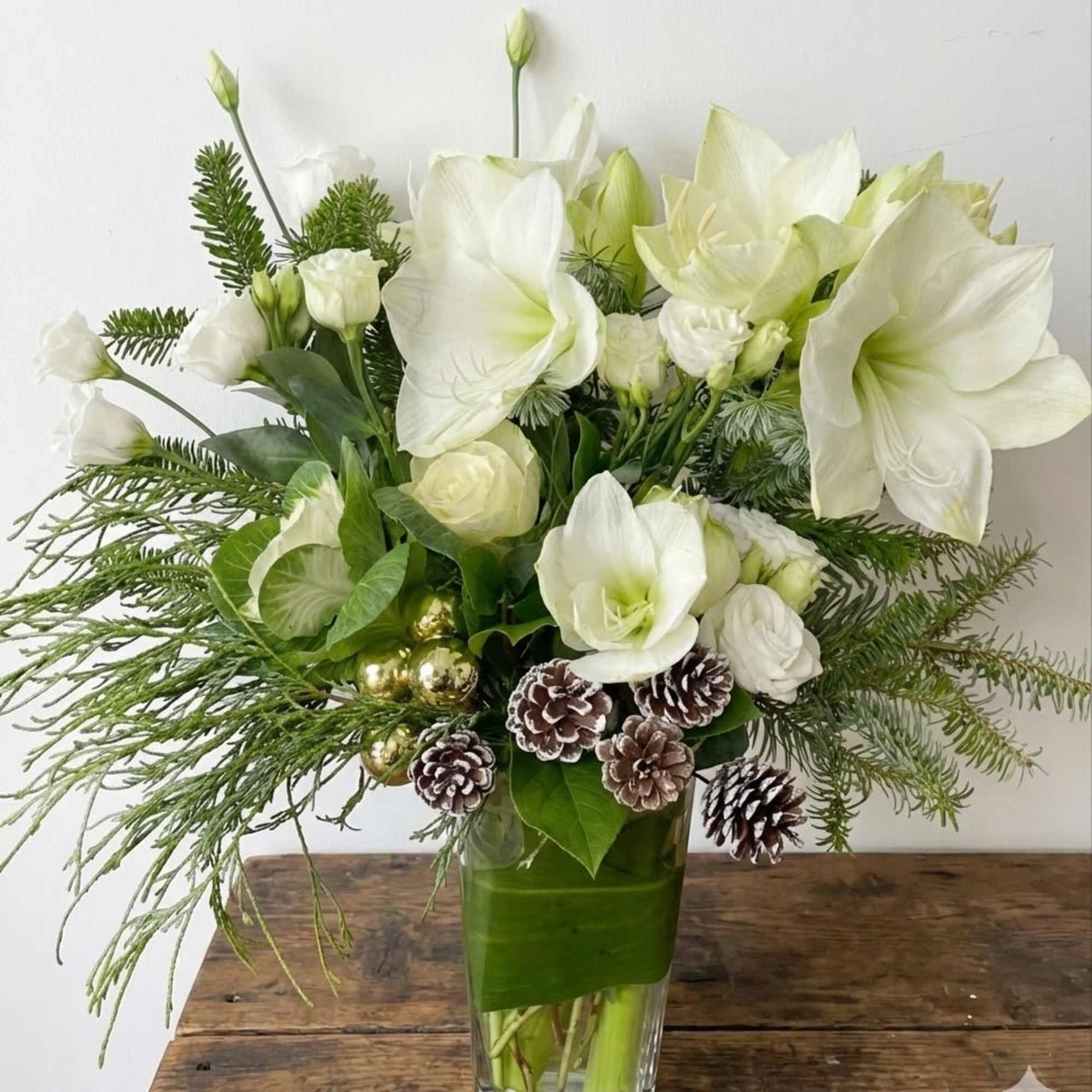 Graceful and refined, Evergreen Elegance is a sophisticated winter arrangement that blends