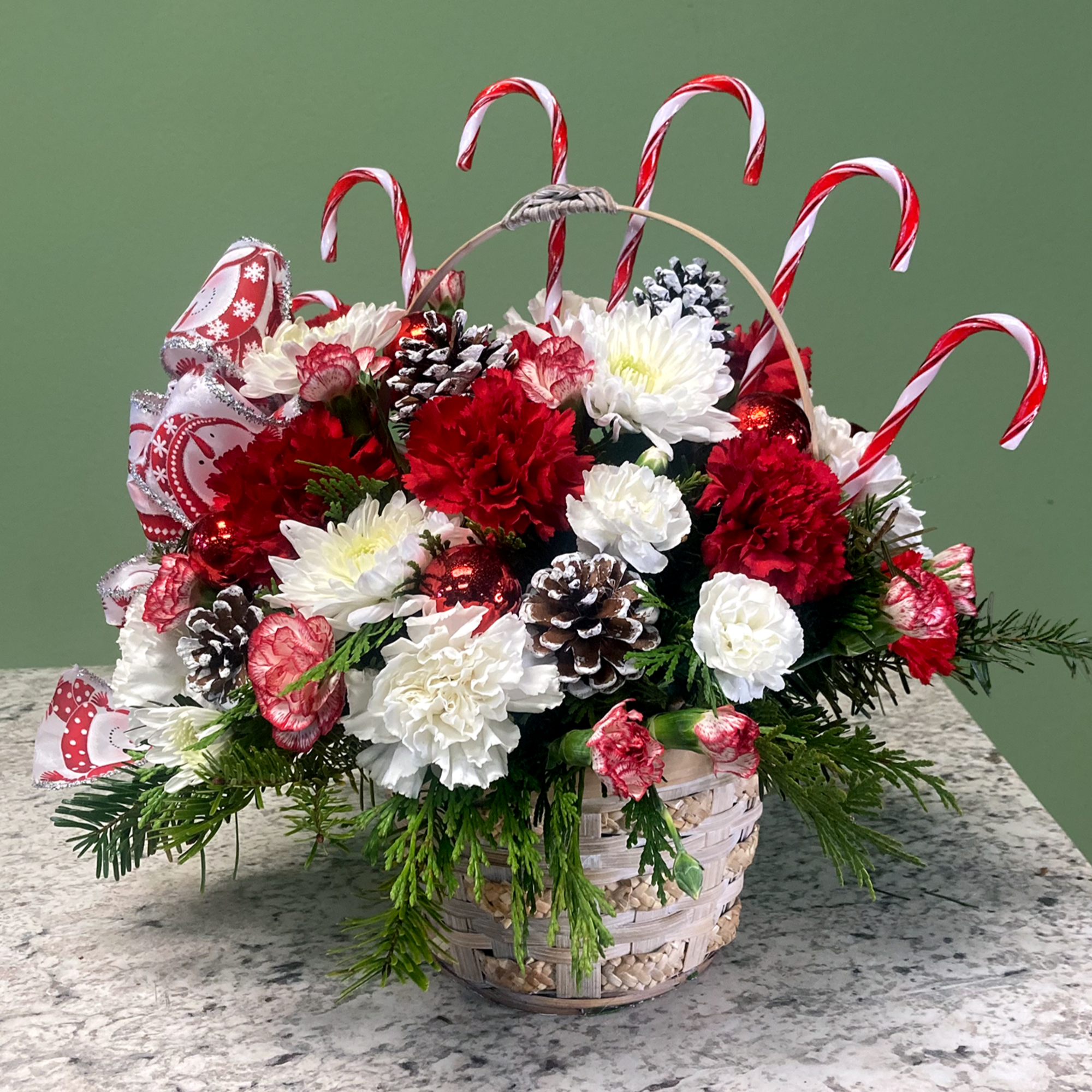 Candy Cane Lane is a holiday flower basket that features festive white