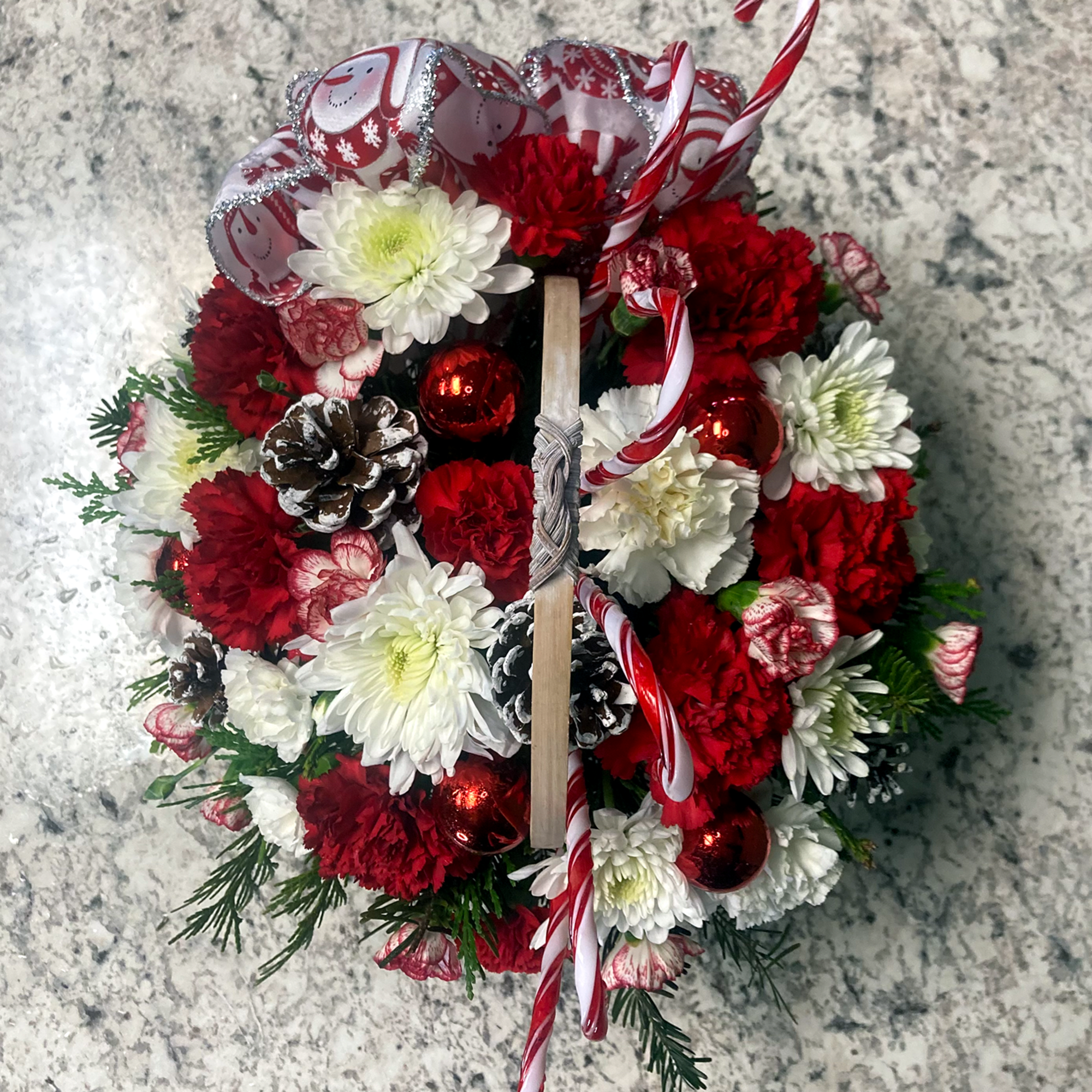 Candy Cane Lane is a holiday flower basket that features festive white