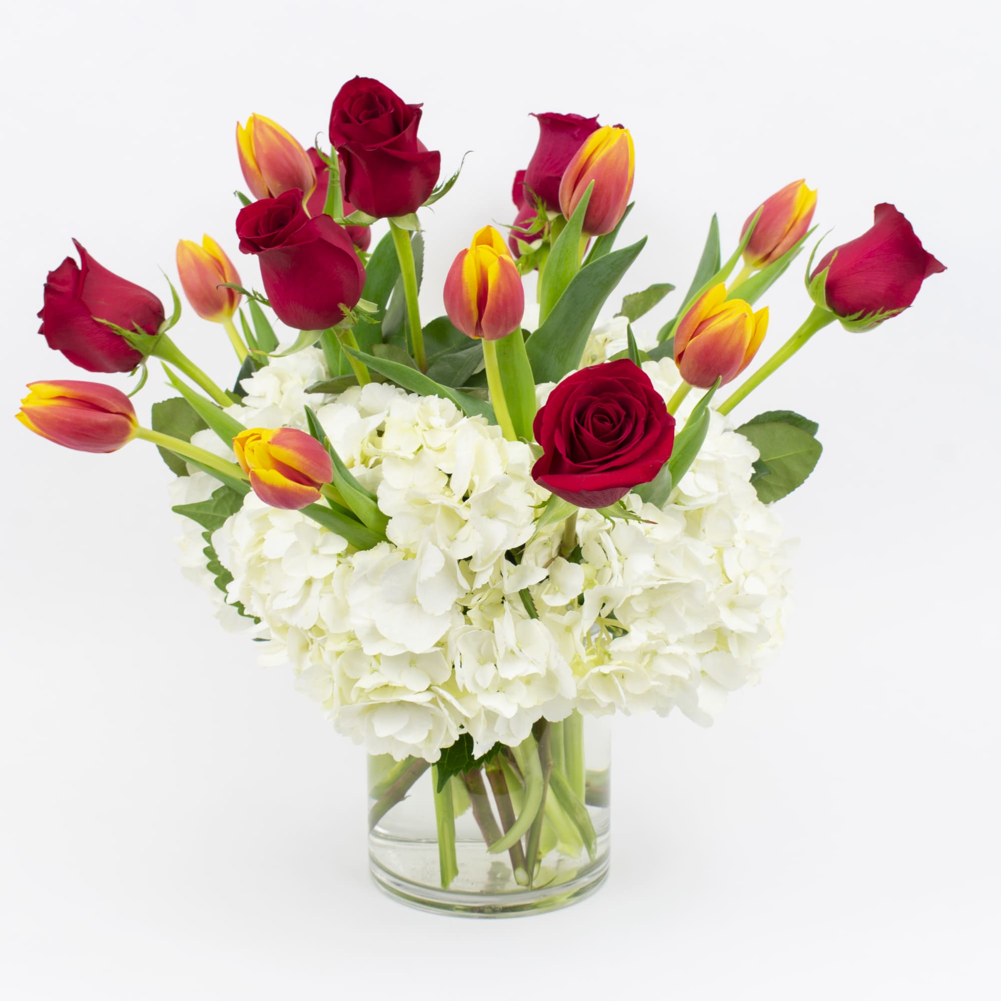 RED ROSES, TULIPS, AND WHITE HYDRANGEA IN A VASE

Fresh and romantic. This