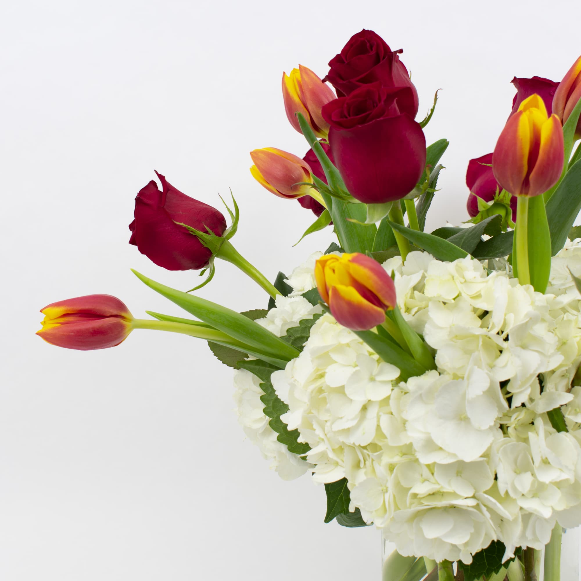 RED ROSES, TULIPS, AND WHITE HYDRANGEA IN A VASE

Fresh and romantic. This