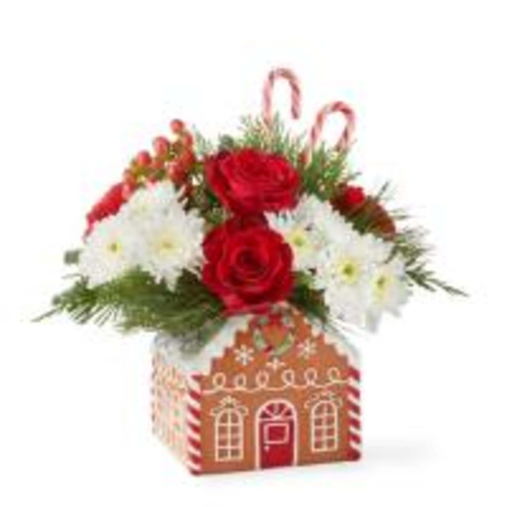 Classic Gingerbread house filled with Christmas greens, red roses, white mums, red